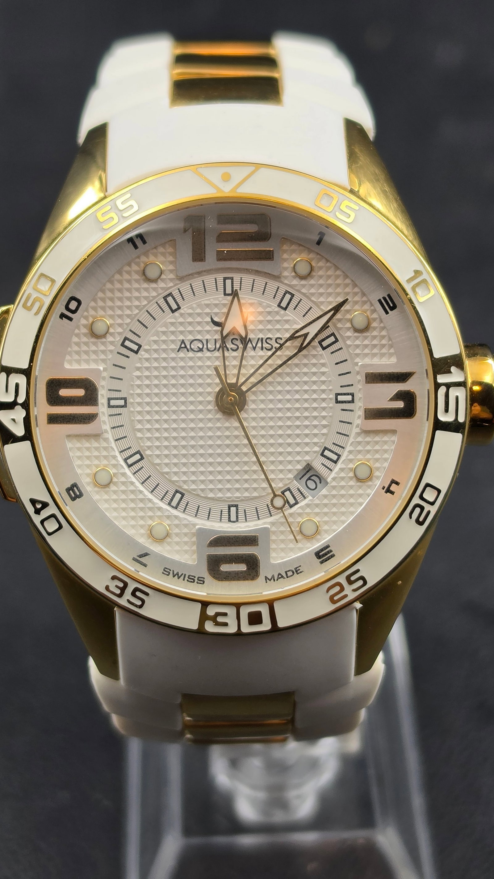 Aquaswiss Trax NOS 44mm Swiss Made Gold-Tone White Rubber Sport Diver Ref Tr11 80G 10138: Aquaswiss Trax reference Tr11 80G 10138, NOS example in excellent unissued condition. The 44.46mm gold-tone stainless steel case features a white and gold-tone unidirectional dive bezel with bold Arab