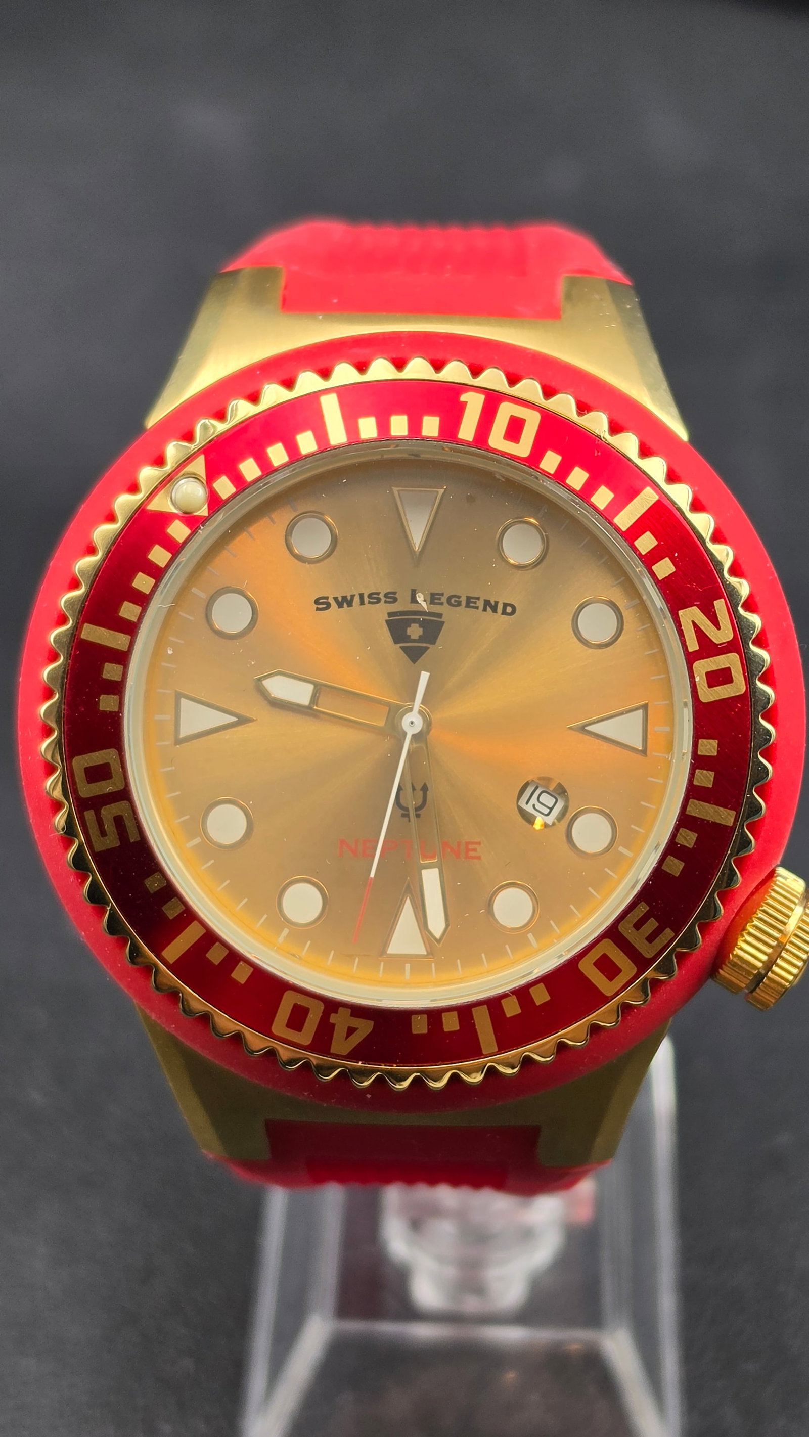 Swiss Legend Neptune Gold-Tone & Red Diver, Swiss Movement, Red Silicone Strap, NOS, c. 2010s: This is the Swiss Legend Neptune diver in a bold gold-tone and red colorway, powered by a Swiss movement and rated water resistant to 10ATM/330 feet. The champagne/gold sunburst dial features applied 
