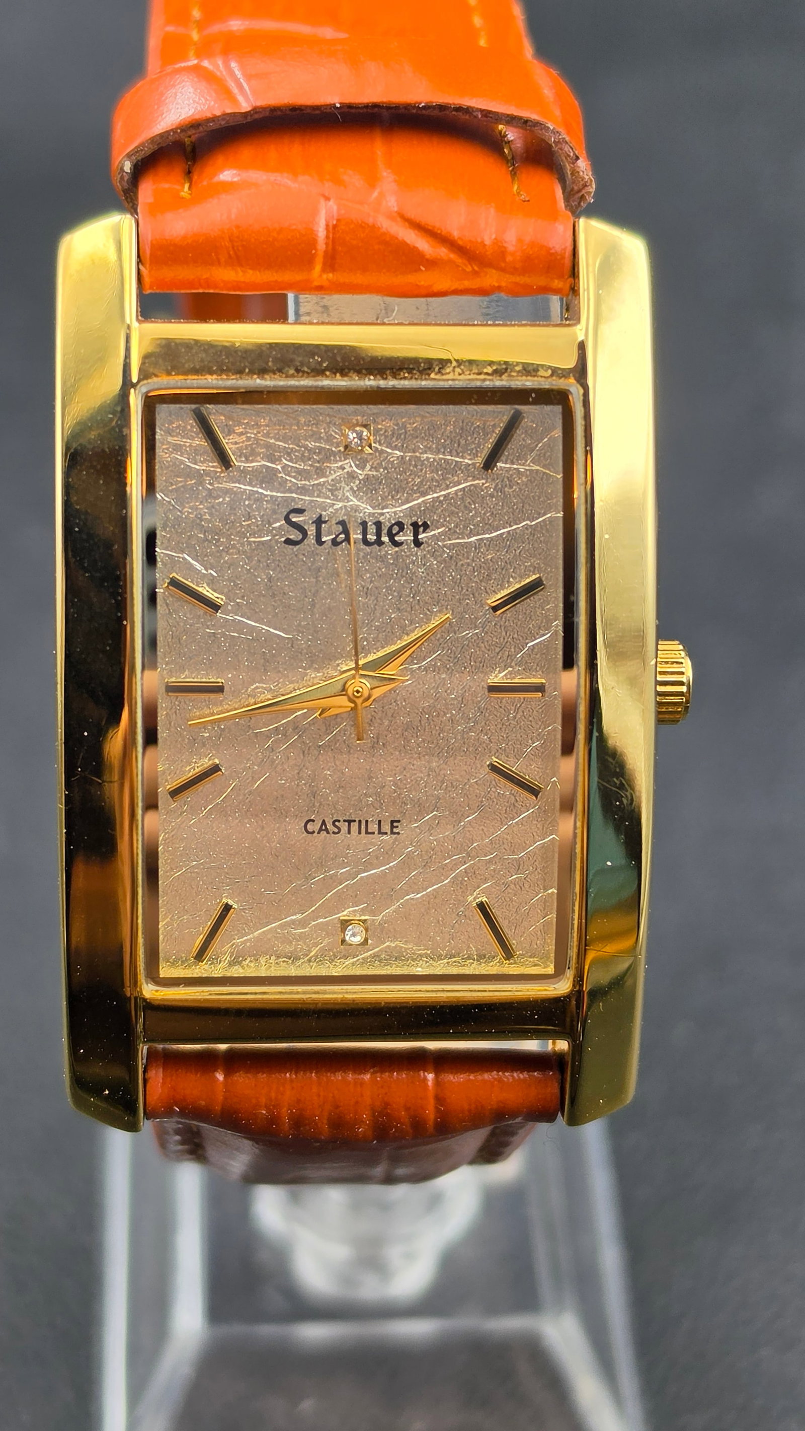 Stauer Castille No. 26694 Gold-Tone Tank Diamond Dial Japan Movement 30mm, Orange Croc Leather, NOS,: This is the Stauer Castille reference 26694, a slim 30mm gold-tone tank-style dress watch powered by a Japanese quartz movement. The champagne/gold crinkle-texture dial is set with two genuine diamond
