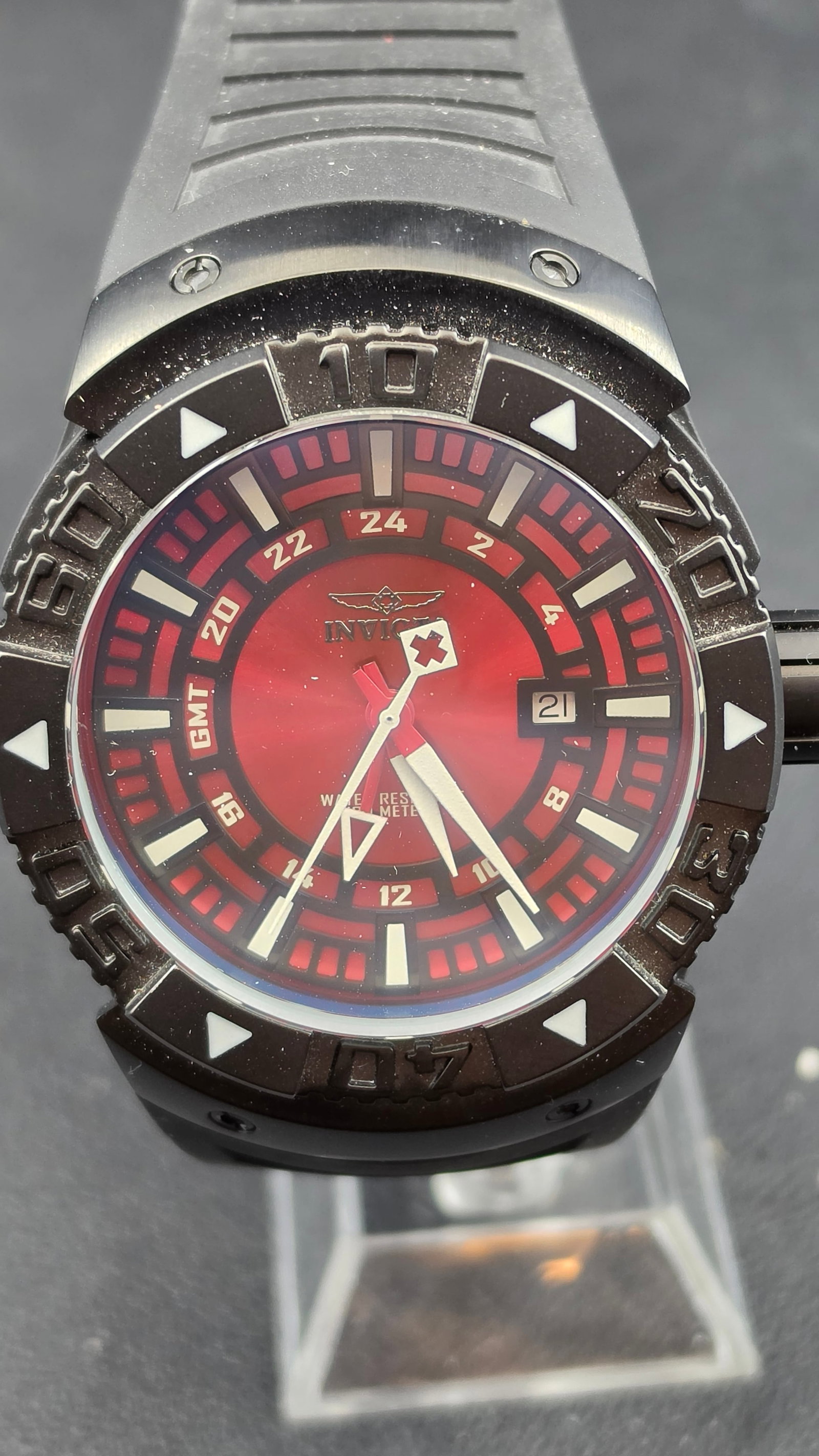 Invicta Model 6990 GMT Swiss Parts 47mm Red Dial Black PVD Case & Rubber Strap, NOS, c. 2010s: This is the Invicta reference 6990, a 47mm GMT sport watch in a fully blacked-out PVD-coated stainless steel case powered by a Swiss parts movement. The deep red sunburst dial is one of the more drama