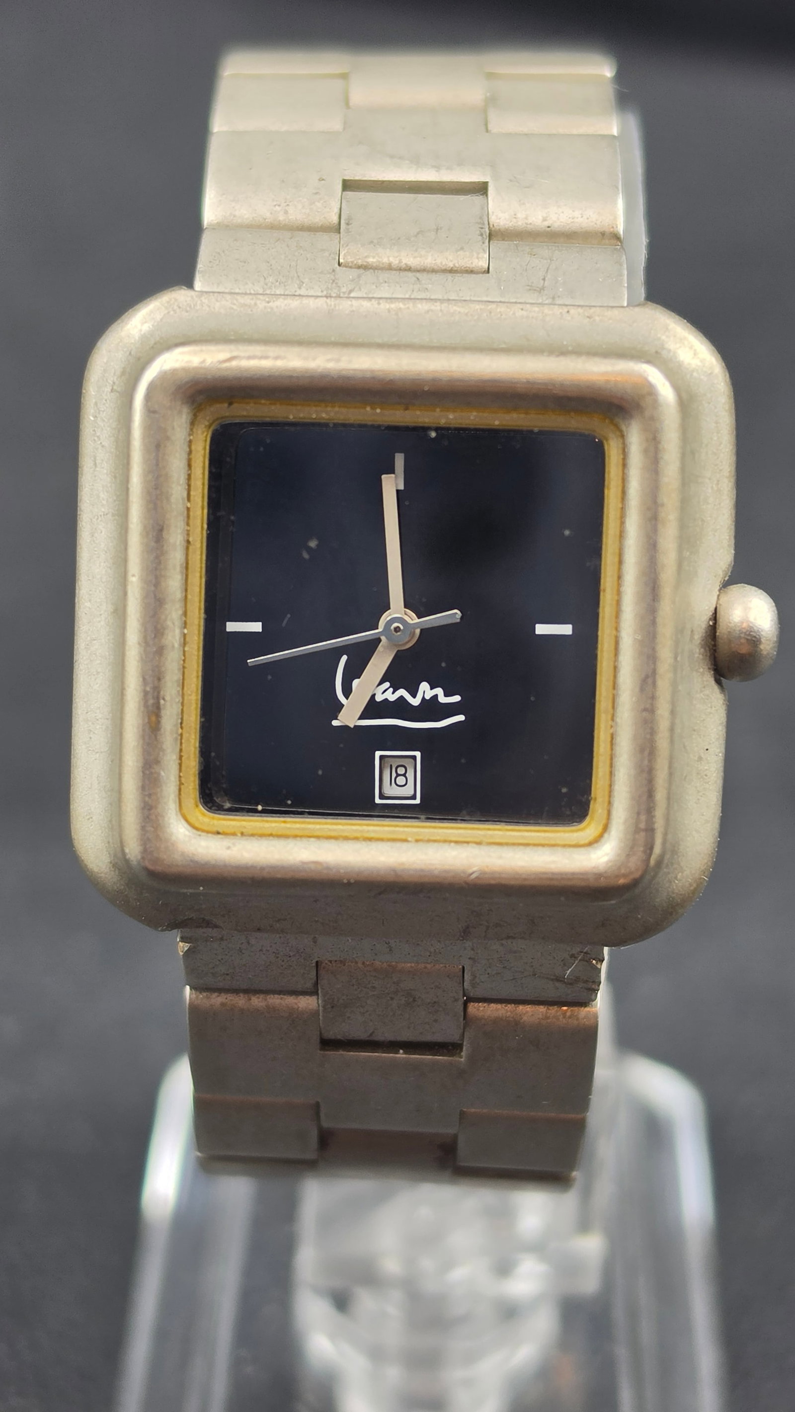Michael Graves Designer Signature Square Black Dial Date Watch MG5015 30mm Stainless Steel Running: This is a vintage Michael Graves designer quartz watch, reference MG/5015, from the postmodern architect and designer's collectible watch line. The cushion-square case measures 30.23mm with a softly r