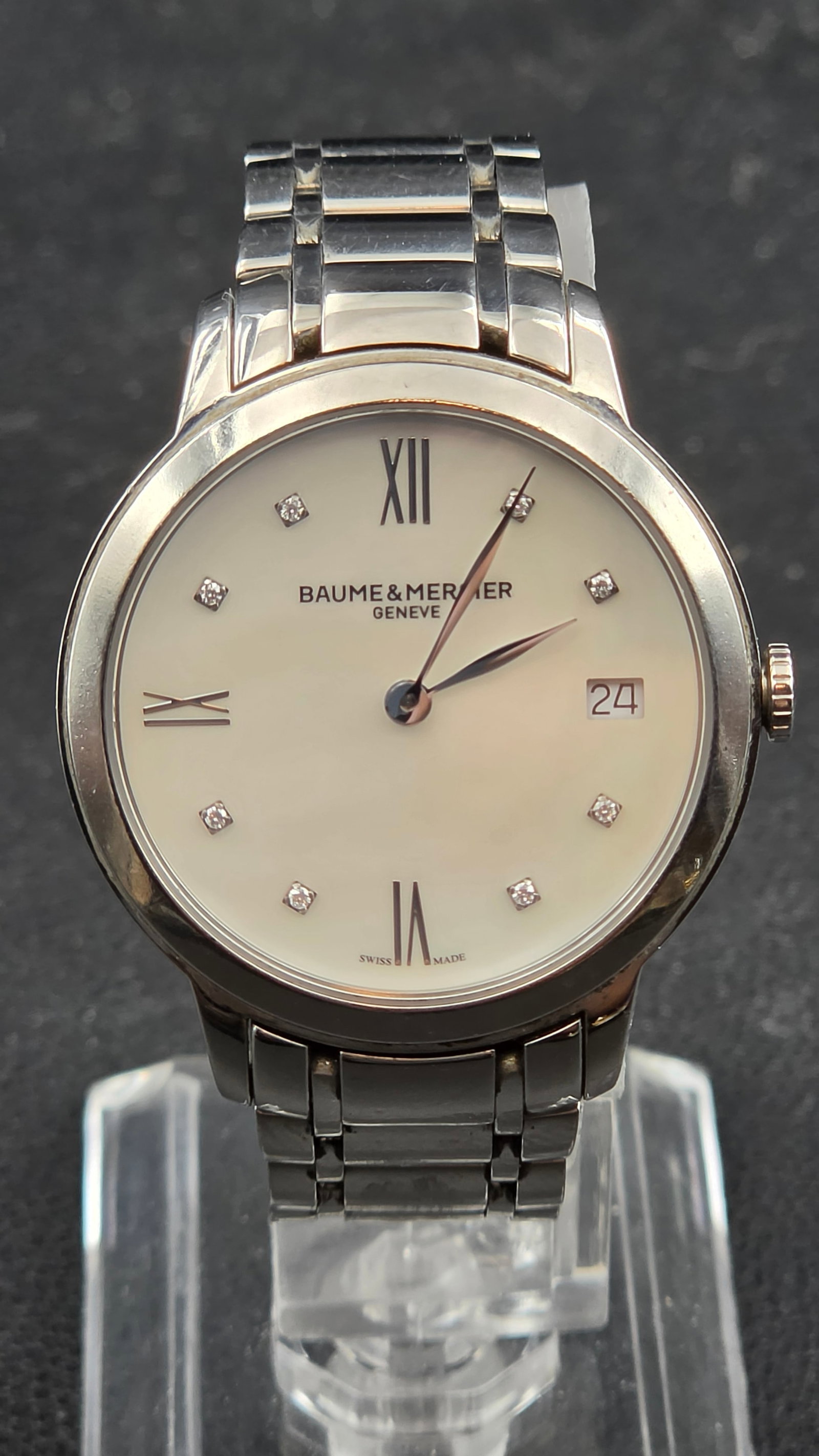 Baume & Mercier Classima 65808 Ladies 31mm MOP Diamond Dial Stainless Steel Quartz Watch w/ Date: This is a genuine Baume & Mercier Classima reference 65808 ladies' wristwatch, presented in a 31.38mm stainless steel case confirmed by the engraved case back stampings reading "65808-SWISS 50M