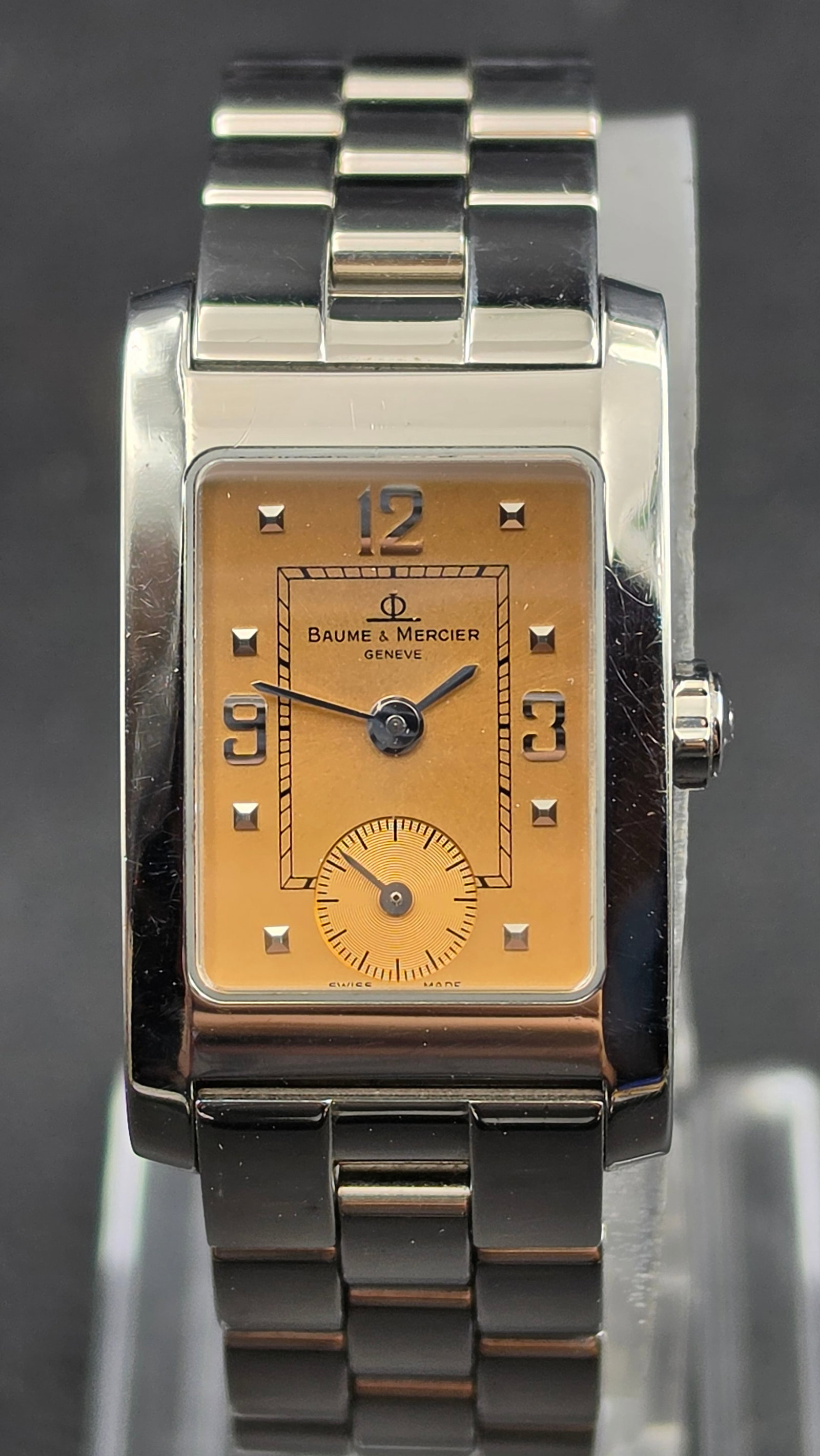 Baume & Mercier Hampton Ladies 20mm Champagne Dial Stainless Steel Quartz Watch w/ Sub-Seconds: This is a genuine Baume & Mercier Hampton ladies' wristwatch in a rectangular stainless steel case measuring 20.24mm wide, confirmed by the engraved case back reading "BAUME & MERCIER GENEVE /