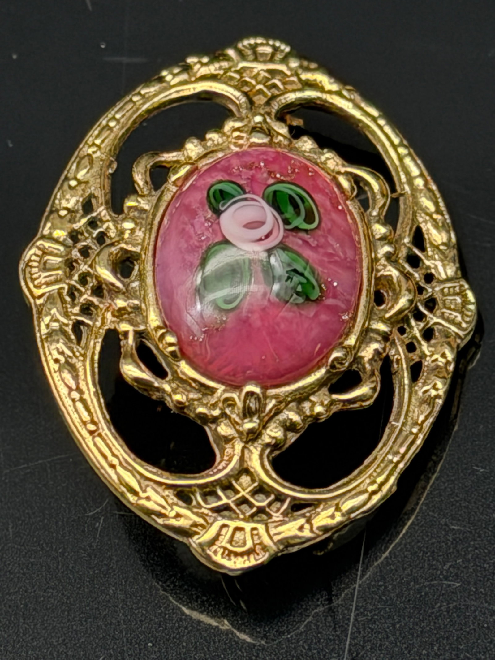 9g-Vintage Art Nouveau Style Pink Floral Glass Cabochon Brooch: Charming vintage brooch featuring an ornate Art Nouveau-inspired gold-tone filigree frame accented with a beautiful pink glass cabochon. The centerpiece showcases a delicate raised floral design with 