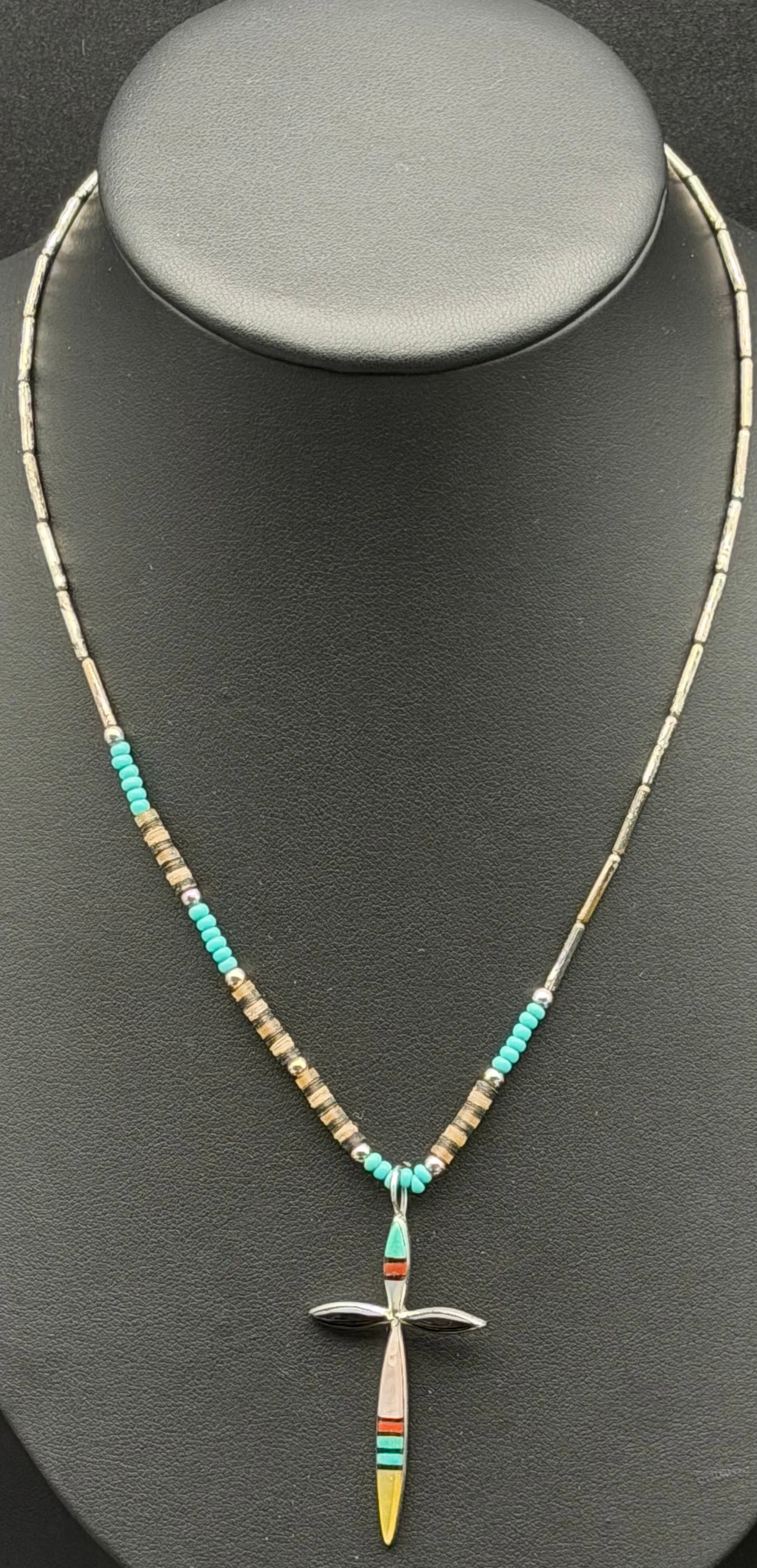 6g-Vintage Zuni Sterling Silver Multi-Stone Inlay Cross Pendant Necklace: Vintage Zuni sterling silver cross pendant necklace featuring traditional Southwestern channel inlay work. The cross is inlaid with turquoise, coral, jet, and yellow shell (or mother-of-pearl) in a cl