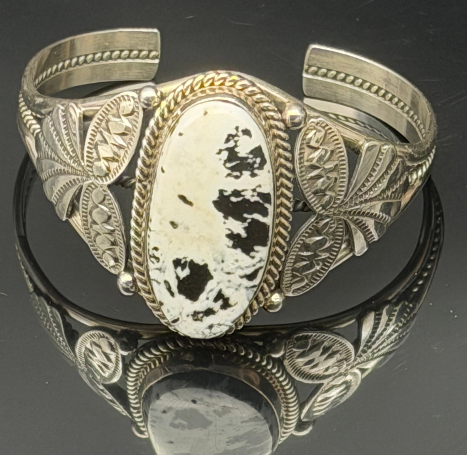 36g-M. Spencer Sterling Silver White Buffalo Turquoise Cuff Bracelet Navajo Signed: Vintage handcrafted sterling silver cuff bracelet signed M. Spencer. Features a large oval White Buffalo-style stone set in a twisted rope bezel with detailed hand-stamped leaf and fan motifs on each 