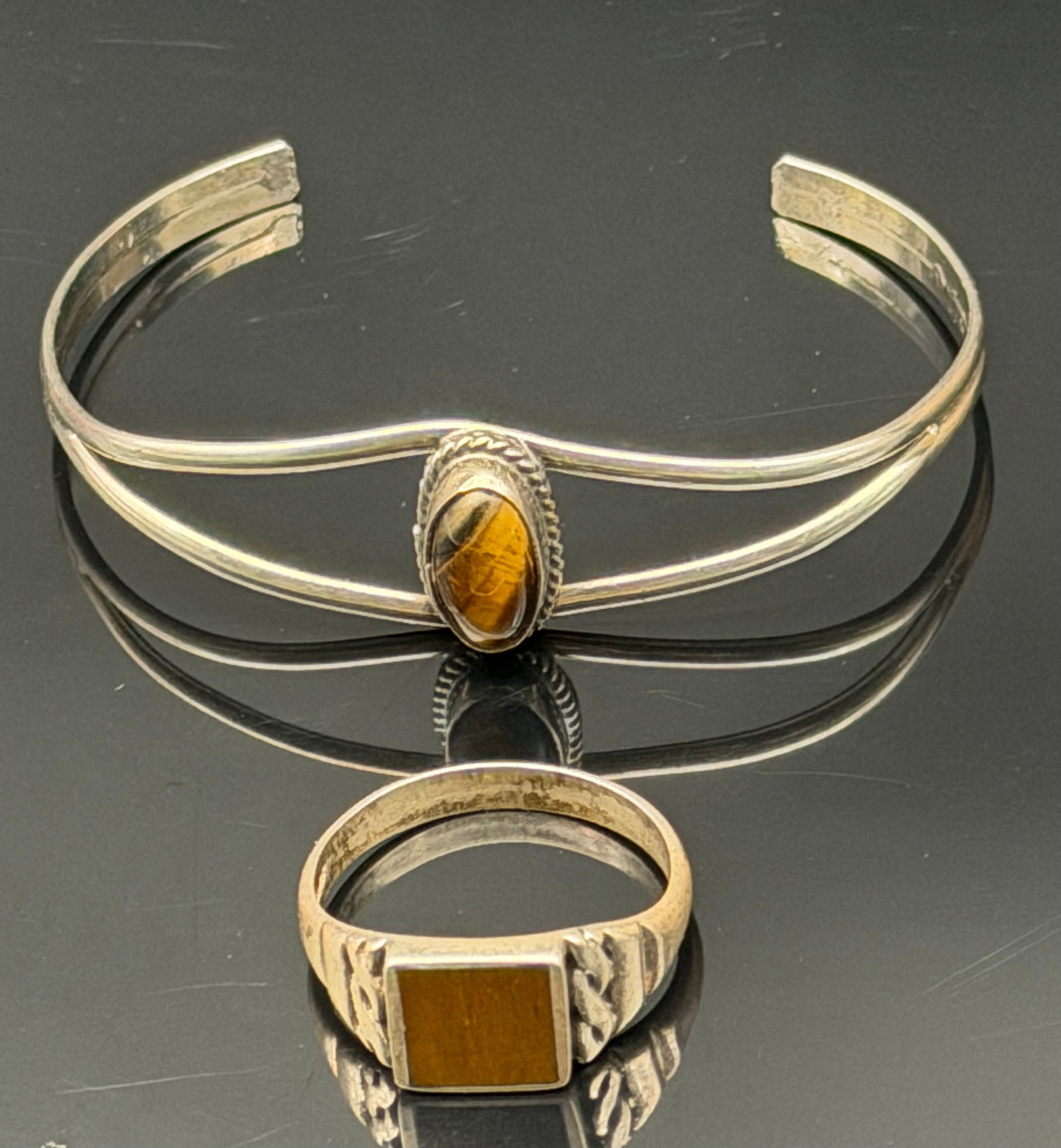 10g-Vintage Sterling Silver Tiger’s Eye Ring & Cuff Bracelet Set Southwestern Artisan: Vintage sterling silver jewelry set featuring a matching Tiger’s Eye ring and open cuff bracelet. The bracelet showcases a polished oval Tiger’s Eye cabochon set in a rope bezel on a graceful doub