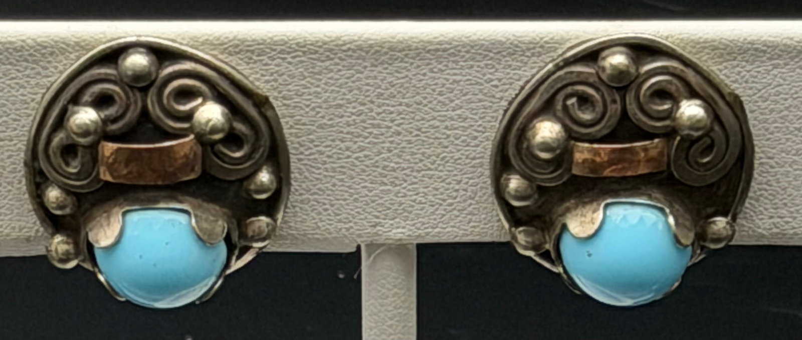 8g-Vintage Sterling Silver Blue Glass Turquoise Look Screw Back Earrings: Vintage sterling silver earrings featuring round Southwestern-inspired designs with decorative scrollwork, bead accents, and light blue cabochon stones. Marked sterling (hallmark worn and partially il