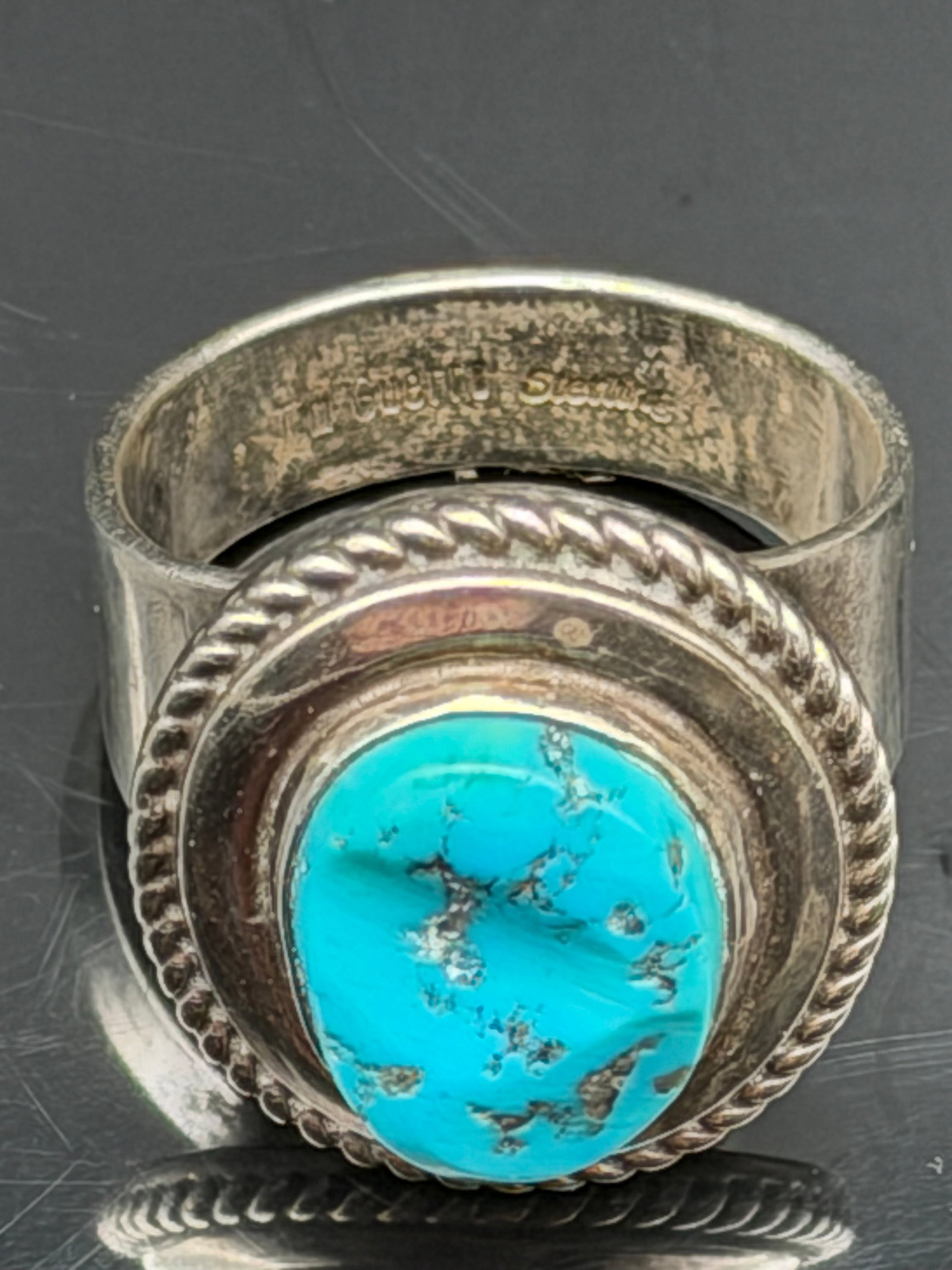 24g-Vintage Tim Guerro Navajo Sterling Silver Natural Turquoise Ring: Vintage signed Tim Guerro sterling silver ring featuring a large natural turquoise cabochon with attractive matrix. The stone is bezel set within a rope-twist border on a substantial sterling silver b