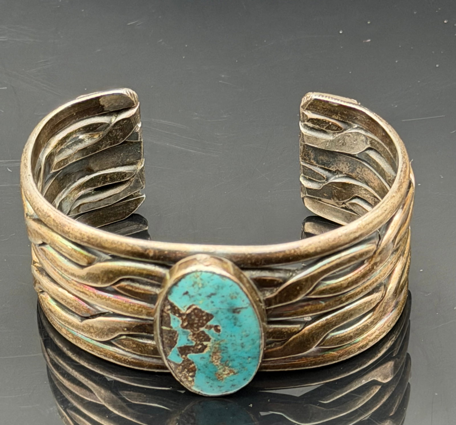 84g-Vintage Sterling Silver Turquoise Openwork Cuff Bracelet: Vintage sterling silver cuff bracelet featuring a natural turquoise cabochon set in a wide openwork multi-row design. The bracelet displays flowing silverwork with a striking turquoise centerpiece. He