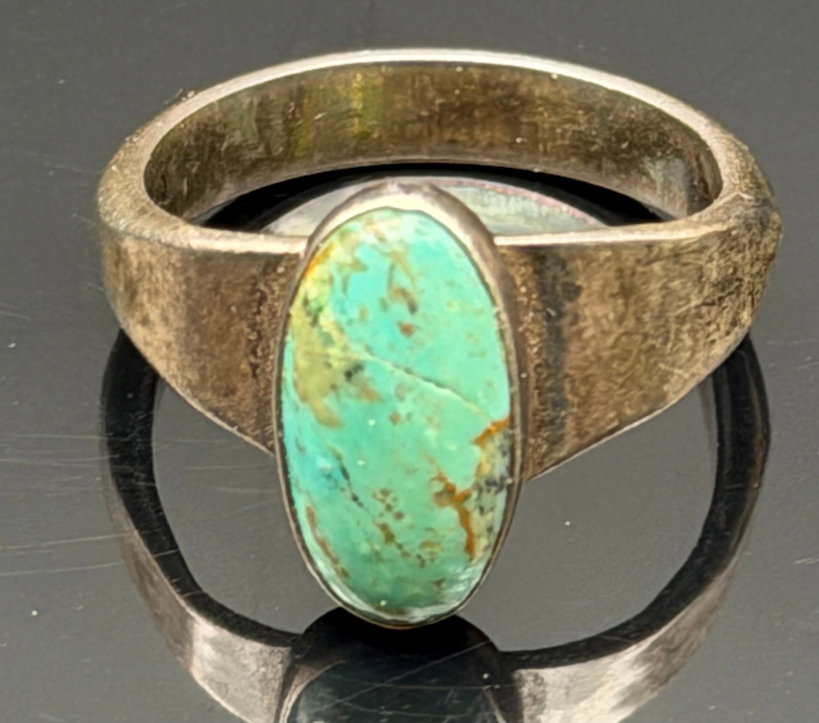 4g-Vintage Turquoise Sterling Silver Southwest Ring: Vintage sterling silver ring featuring a natural turquoise cabochon in a simple bezel setting. The minimalist design and aged patina give it a classic Southwestern/Native American-inspired look. The t