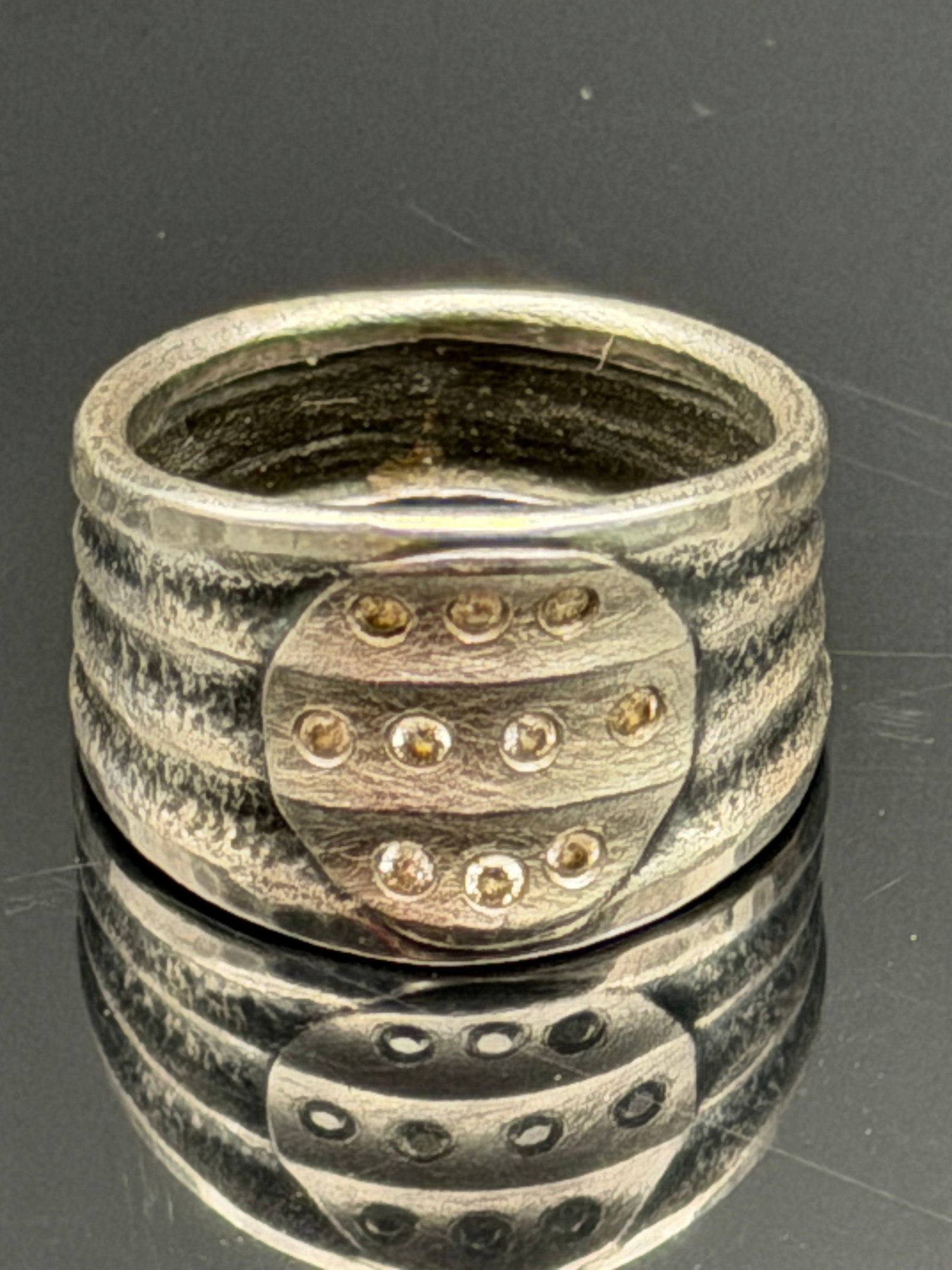 7g-Vintage Artisan Sterling Silver Modernist Ring: Unique handcrafted sterling silver modernist ring featuring a wide textured band and an applied oval centerpiece accented with gold-tone bead details. Signed by the artist (signature partially illegib