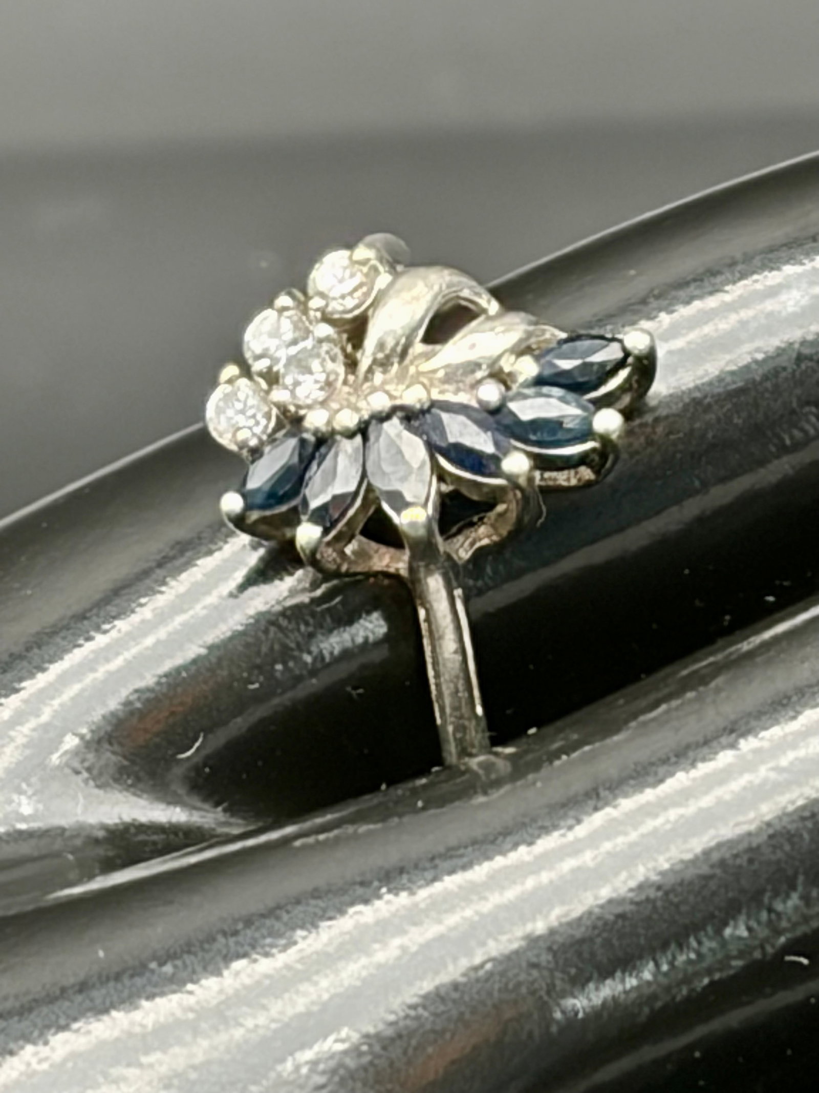3.5g 925 Silver Sapphire CZ Floral Cluster Ring: Elegant sterling silver ring featuring deep blue marquise-cut sapphire-colored stones arranged in a floral cluster with sparkling clear CZ accents. Weighs 3.5 grams. Delicate and timeless design suita