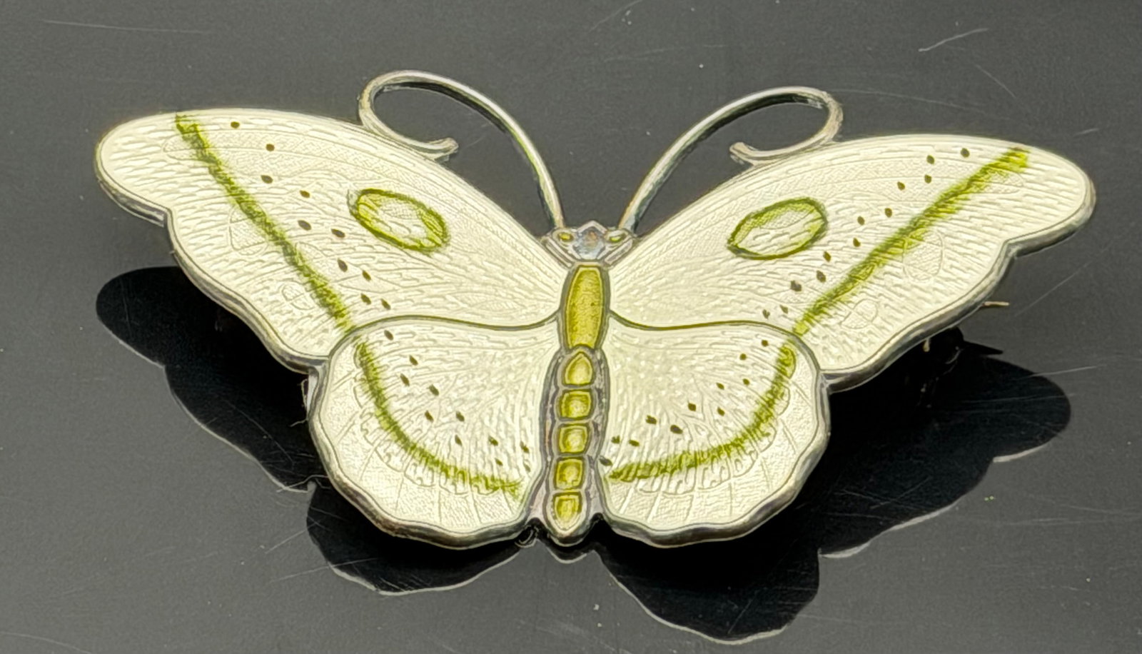 18g-Vintage Norwegian Sterling Silver Enamel Butterfly Brooch White Green Norway JE 925S: Vintage Norwegian sterling silver butterfly brooch featuring elegant white guilloché enamel with soft green accents and fine engraved wing details. Marked “STERLING 925S NORWAY” with JE maker