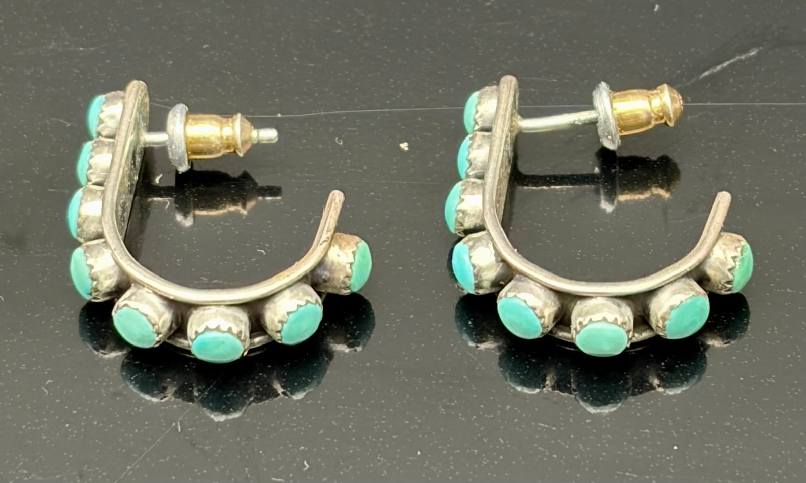 3.5g Turquoise Sterling Silver Half Hoop Earrings: Vintage sterling silver half-hoop earrings featuring seven turquoise cabochons in a classic Southwestern style. Lightweight and comfortable with a distinctive curved design. Total weight 3.5g. A versa