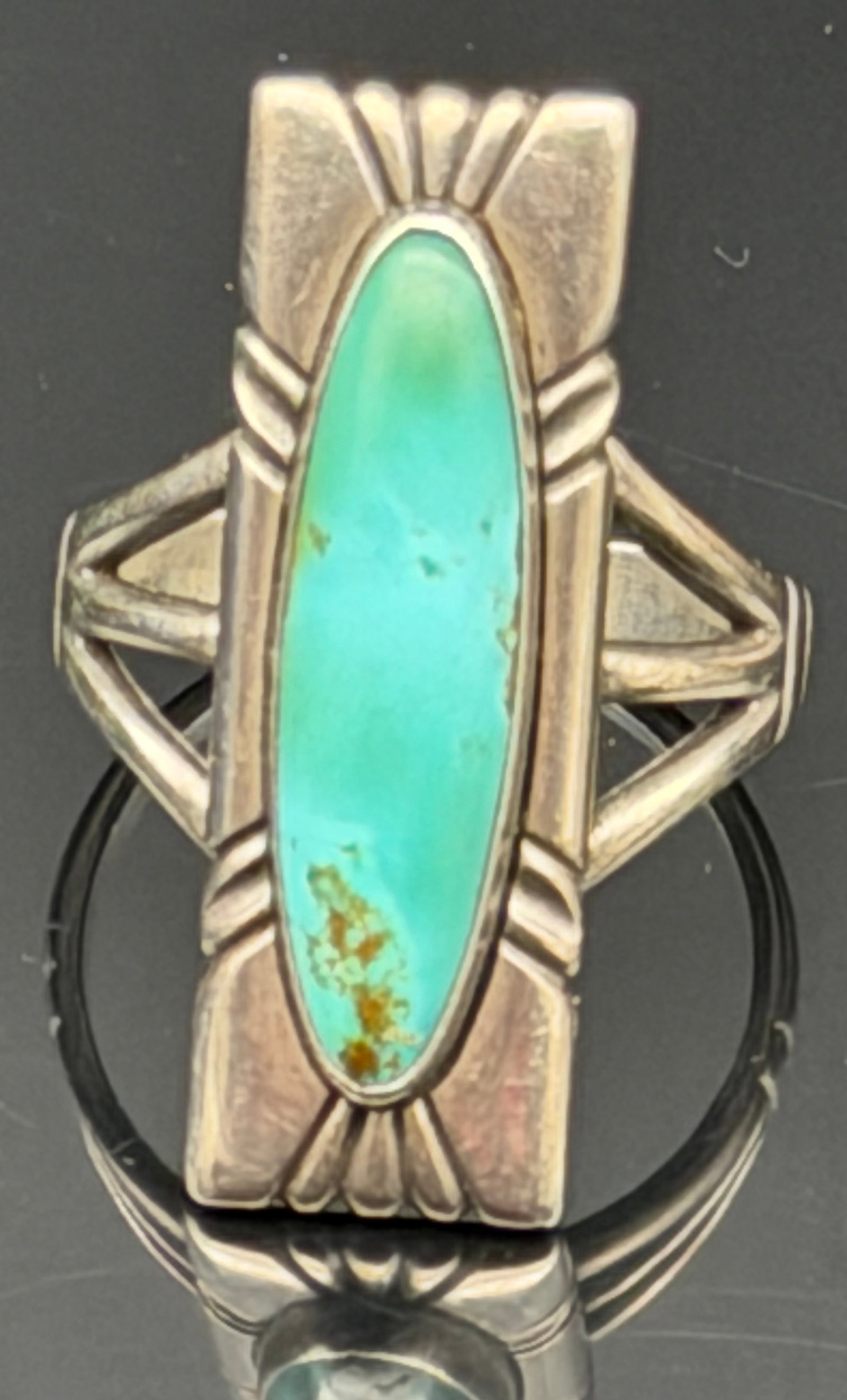 9g-Vintage Sterling Silver Turquoise Ring: Vintage sterling silver ring featuring a striking elongated turquoise cabochon set in a handcrafted Southwestern-style mounting. The geometric split-shank design frames the stone beautifully and gives