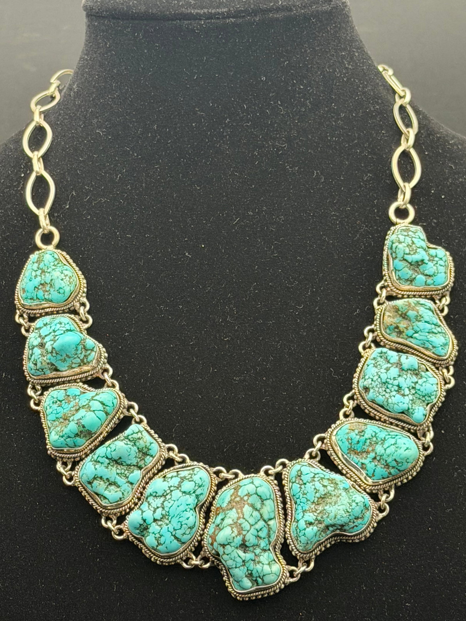 127g-Large Southwestern Turquoise Nugget Statement Necklace Silver Tone: Stunning Southwestern-style statement necklace featuring eleven large freeform turquoise stones with beautiful matrix patterns. Each stone is individually bezel set and linked together to create a dra