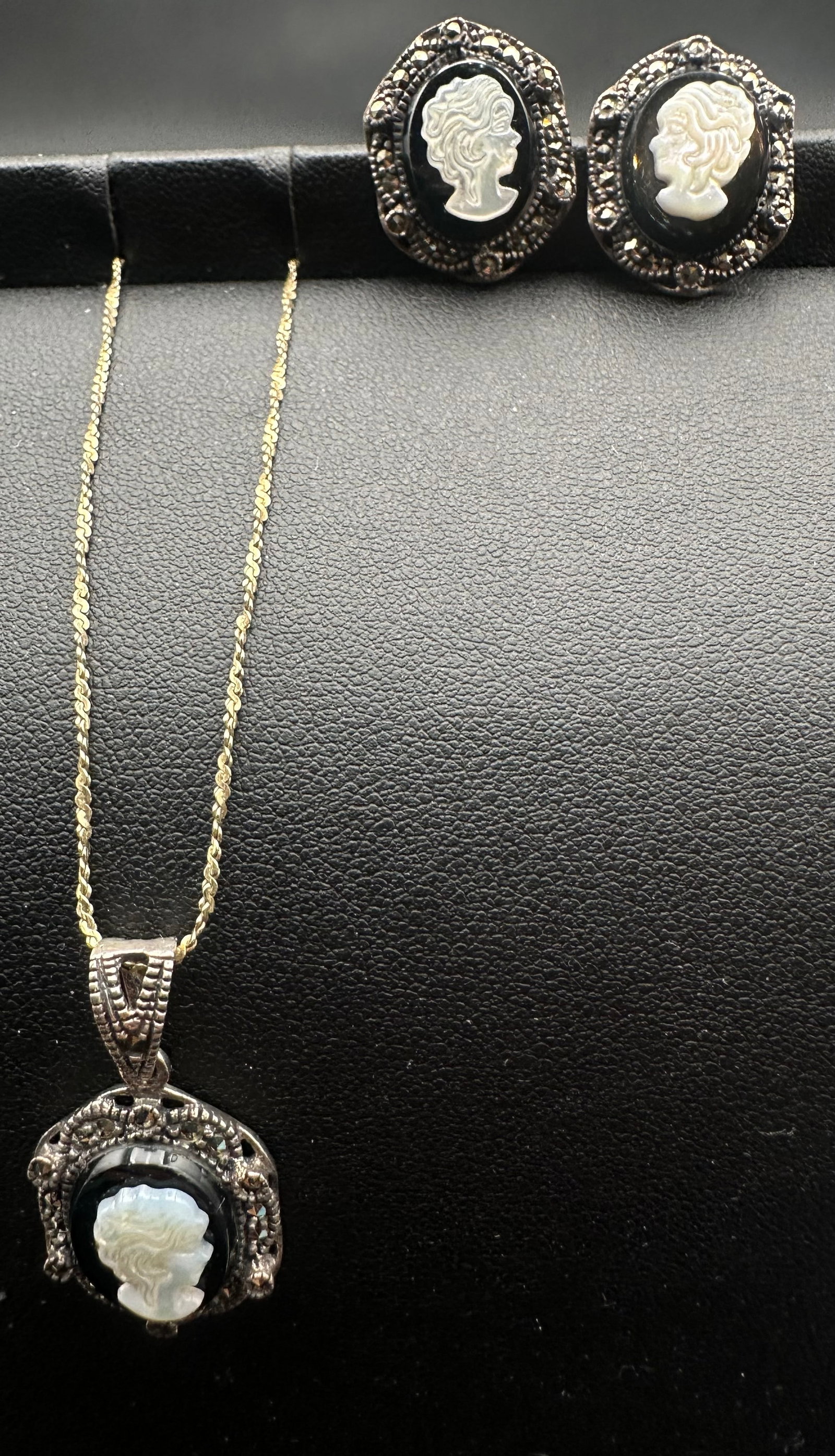 Vintage Sterling Silver Marcasite Cameo Necklace & Earrings Set 11g: Vintage sterling silver jewelry set featuring a pendant necklace and matching pierced earrings. Each piece is adorned with a carved mother-of-pearl cameo profile set against a black background and sur