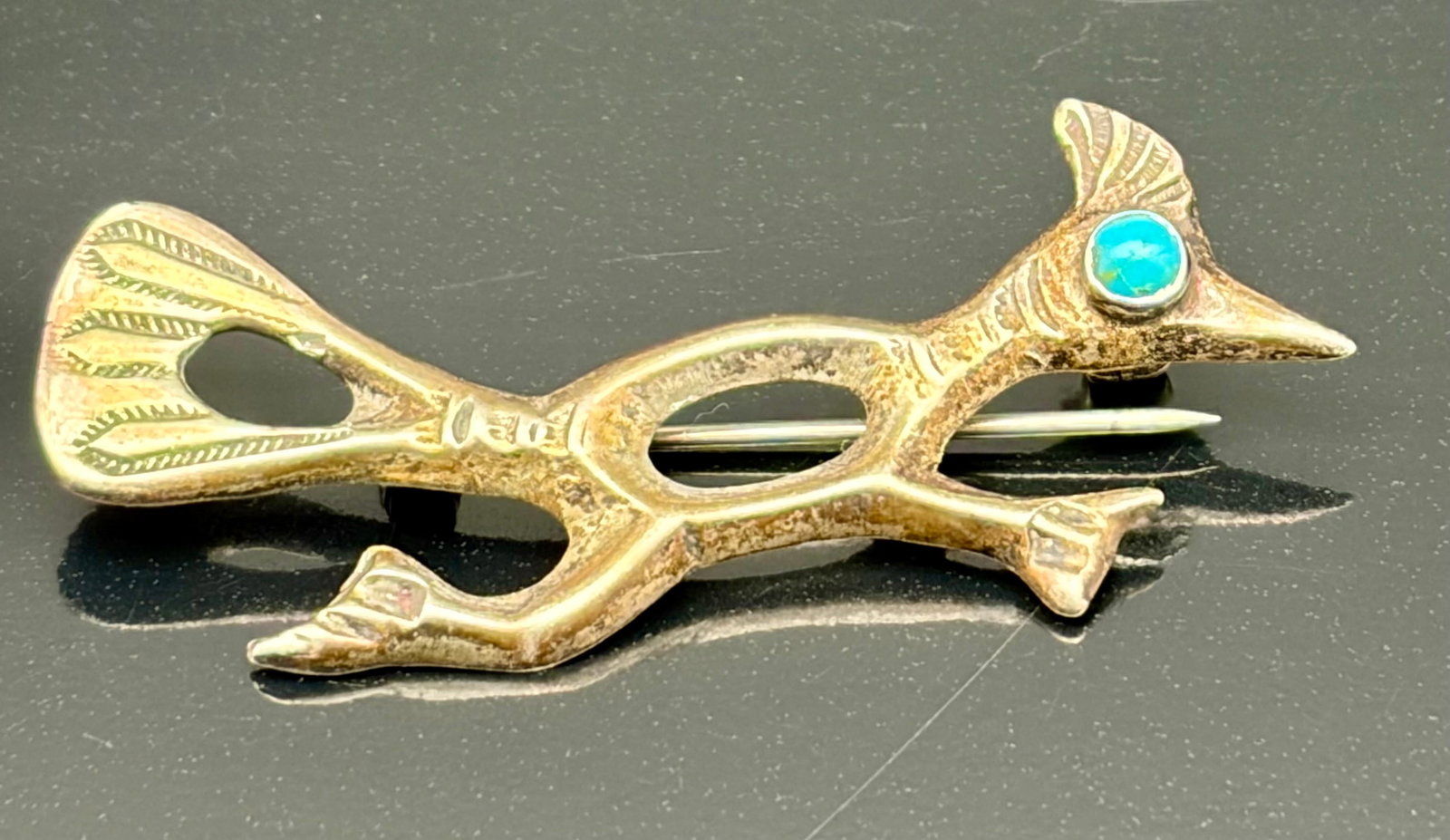 5.6g Vintage Roadrunner Turquoise Accent Brooch Pin: Vintage roadrunner bird brooch featuring a turquoise-colored stone accent and elegant openwork design. Weighing 5.6 grams, this Southwestern-inspired piece showcases detailed craftsmanship with styliz