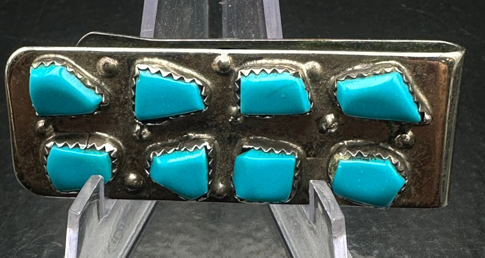 Native American Turquoise Money Clip 16g: Vintage Native American money clip featuring eight turquoise stones set in sawtooth bezels on a hand-crafted silver mount. The reverse is engraved “CURT’S CHEAMA.” Traditional Southwestern d
