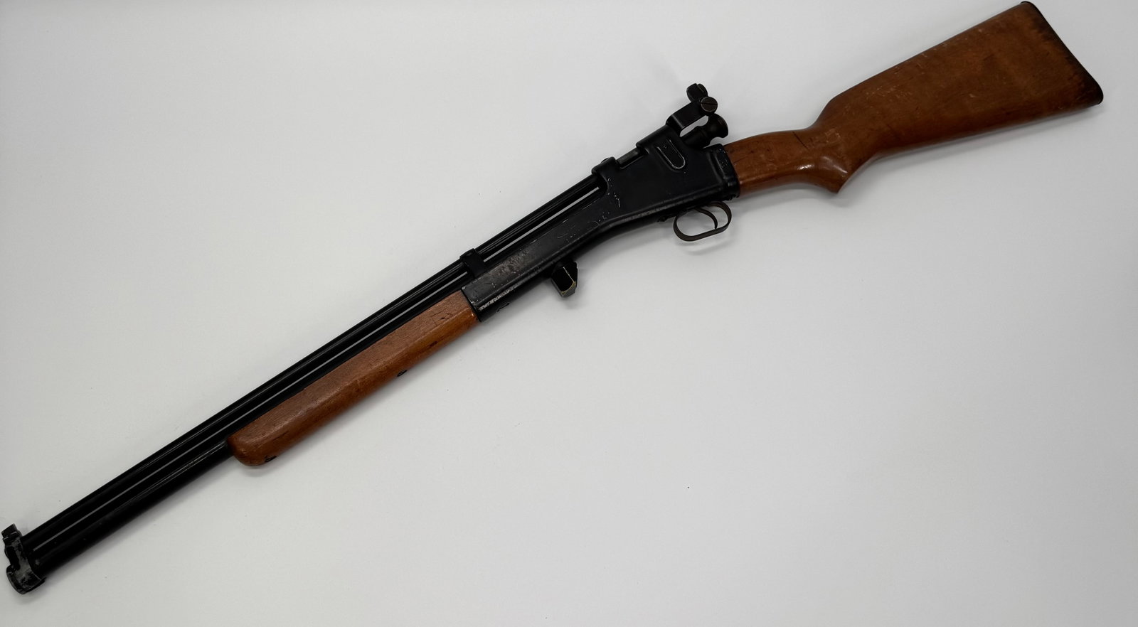 Vintage Crosman Arms Co Air Rifle Rochester NY: Vintage Crosman Arms Company pneumatic air rifle manufactured in Rochester, New York, U.S.A. Features a steel receiver with Crosman logo, wood stock, adjustable rear sight, and pump-action pneumatic d