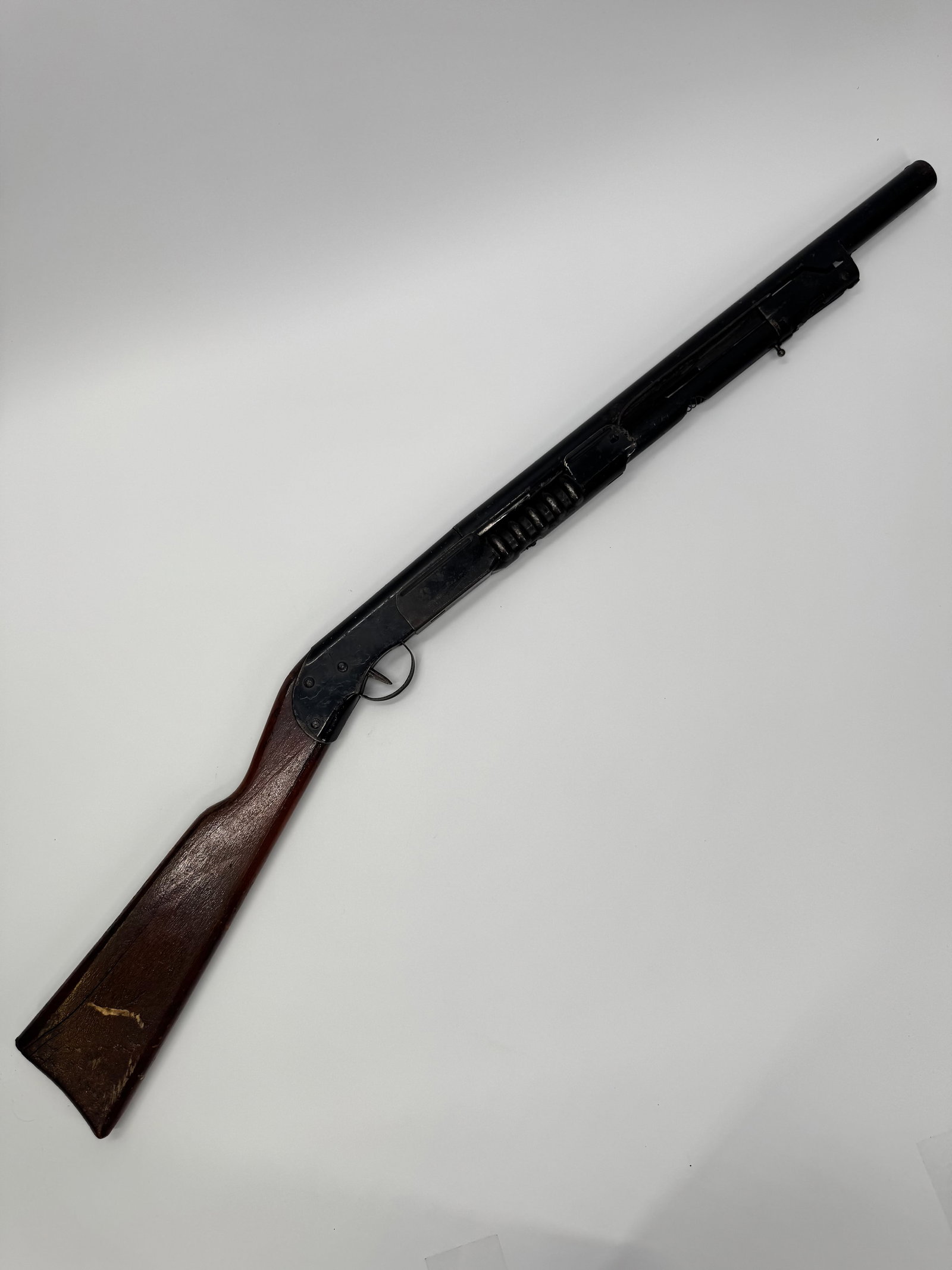 Vintage Pump Action BB Gun Air Rifle w/ Wood Stock: Vintage pump-action BB gun/air rifle featuring a blued steel body, ribbed pump forearm, and hardwood stock. Classic mid-century design with a tubular barrel and manual pump action. The rifle retains i