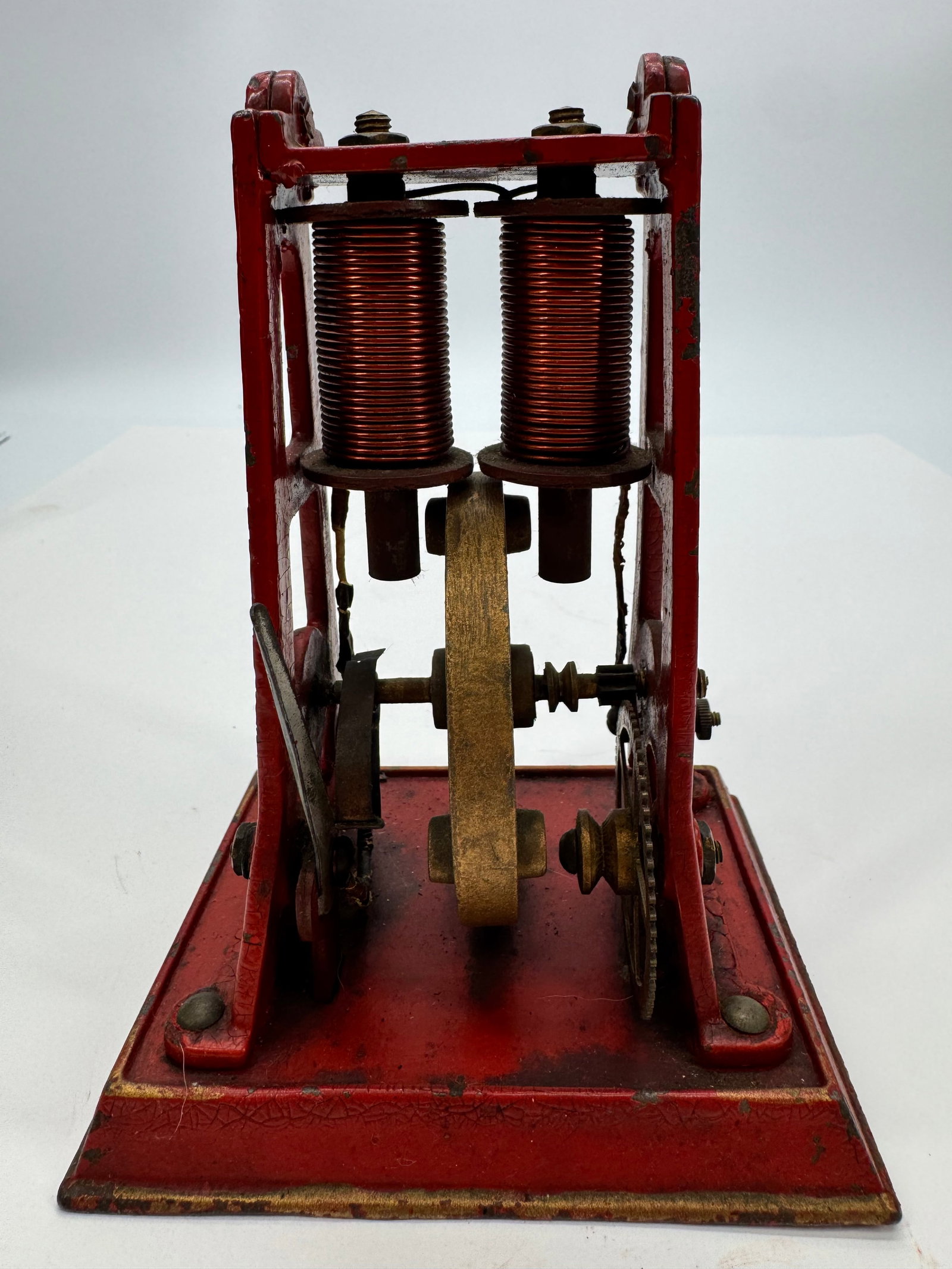 Antique Weeden Belt-Driven Toy Electric Motor: Original antique Weeden belt-driven toy electric motor dating to the early 1900s. Features a cast iron base with upright frame, pulleys, and exposed mechanical components designed for use with a belt-
