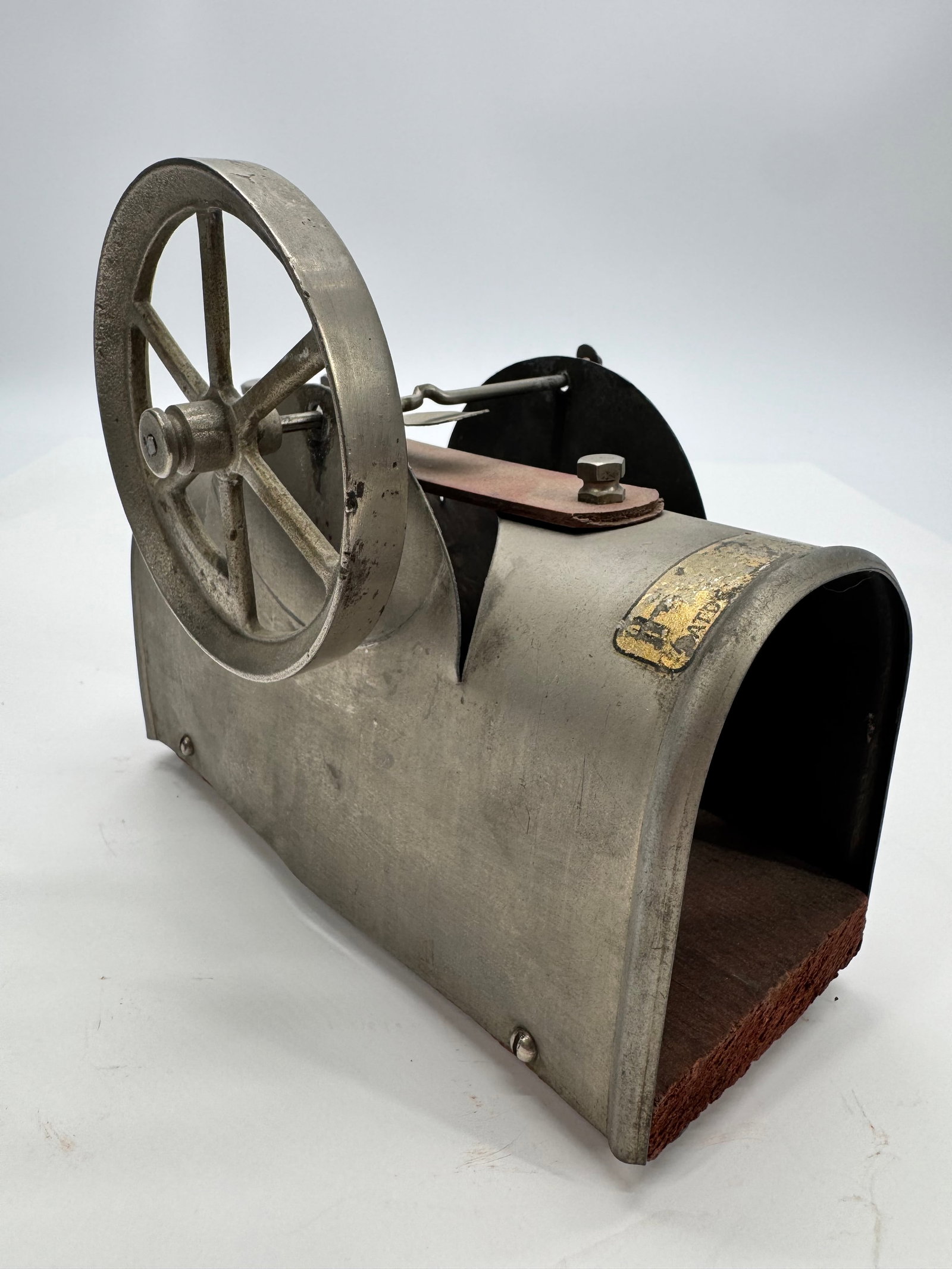 Antique Electromagnetic Toy Engine Pat. 1905-1906: Antique electromagnetic demonstration engine featuring a cast flywheel, oscillating contact mechanism, and original metal tunnel-style housing. Retains a partial patent decal showing patent dates Dec.