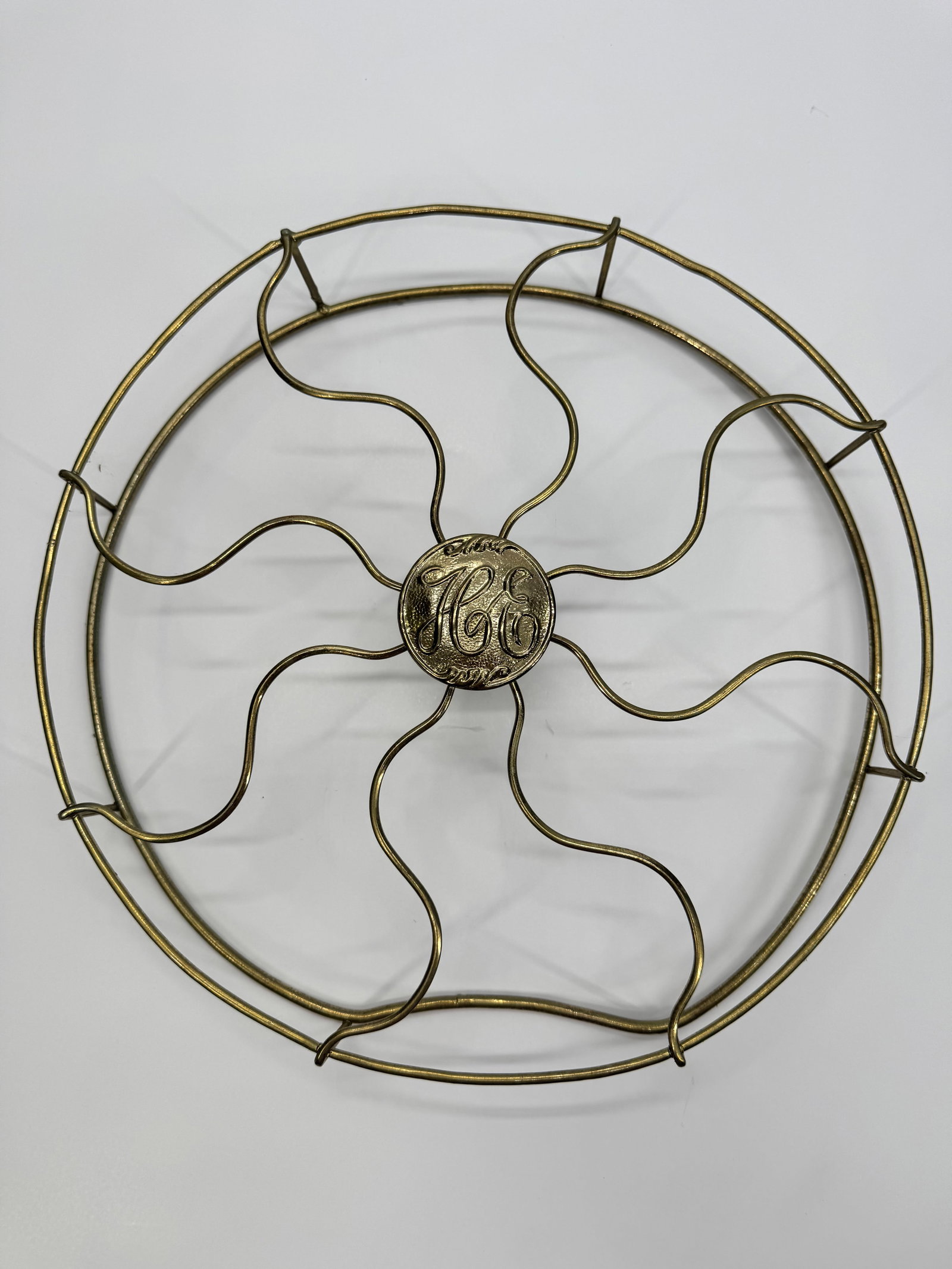 Antique General Electric GE Fan Cage Guard Brass Wire 12” Desk Fan: Original antique General Electric fan cage featuring the classic eight-wave wire design and decorative GE center medallion. Nickel-plated brass construction from the early 1900s. Removed from an early