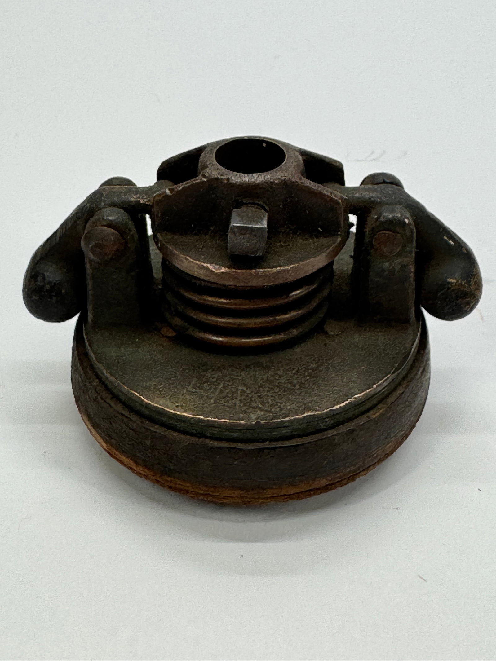 Antique Cast Iron Line Shaft Hanger Bearing Cap Industrial Machinery Part: Original antique cast iron line shaft bearing cap featuring hinged side clamps and a spring-loaded center assembly. Once used in overhead power transmission systems in factories and workshops during t