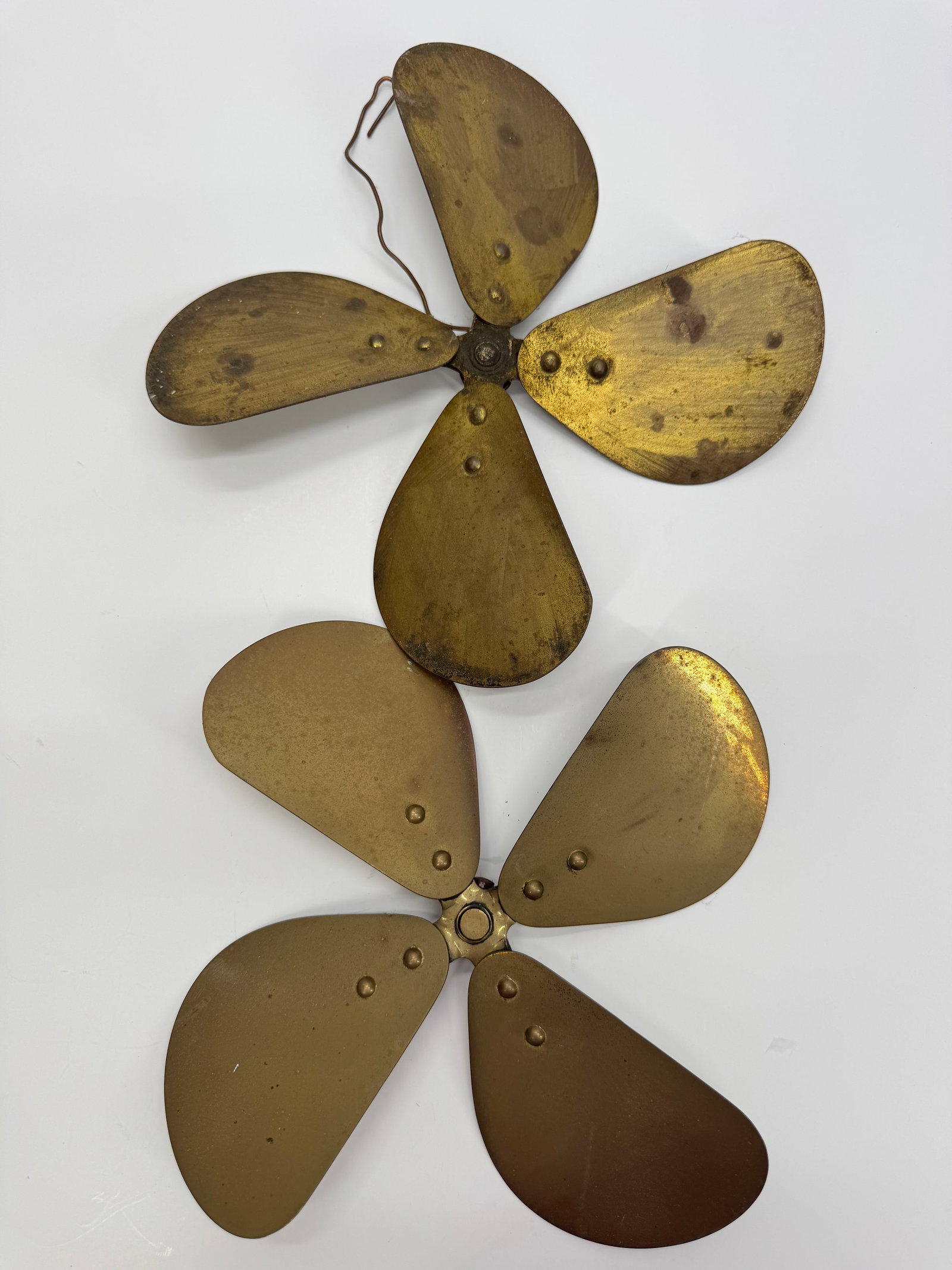 Lot of 2 Antique Brass 4-Blade Electric Fan Blade Assemblies c.1900-1920: Lot of two antique early 20th-century brass electric fan blade assemblies. Each features four riveted brass blades with original hubs and attractive aged patina. One retains an old balancing wire. Ide