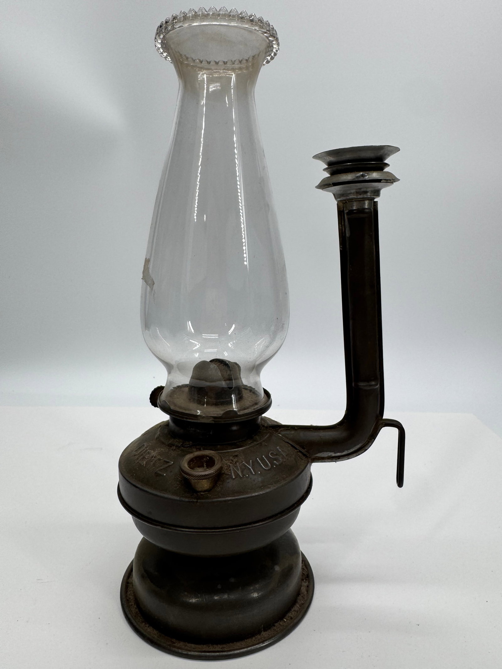 Antique Bestov Hand Kerosene Oil Lantern with Original Glass Chimney: Antique Bestov Hand portable kerosene lantern featuring its original embossed metal font marked “BESTOV HAND M.U.S.” Retains the clear glass chimney with decorative crimped rim and side carryi