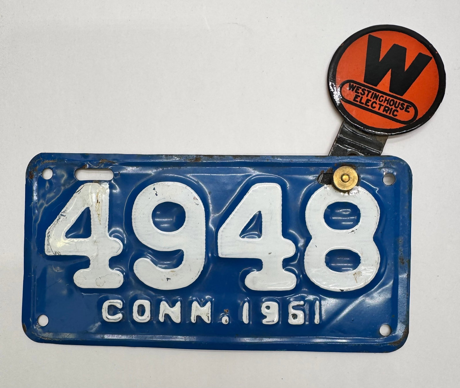 1951 Connecticut License Plate w/ Westinghouse Electric Topper: Vintage embossed Connecticut 1951 license plate numbered 4948 fitted with an original Westinghouse Electric advertising topper. Features the iconic orange and black Westinghouse emblem with original m