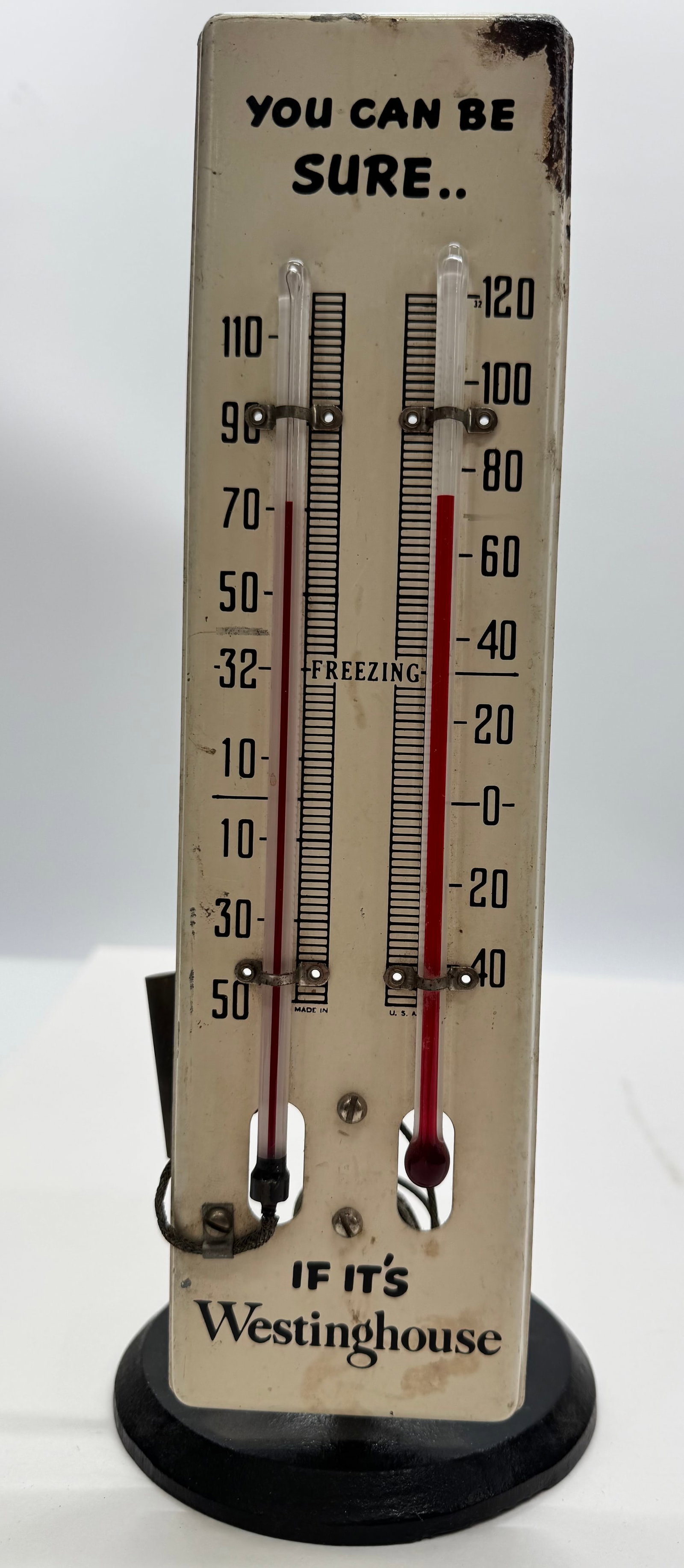 Vintage Westinghouse Countertop Advertising Thermometer Display: Original Westinghouse Electric countertop advertising thermometer featuring the slogan, "You Can Be Sure... If It's Westinghouse." Painted metal face with dual Fahrenheit thermometers mounted on a hea