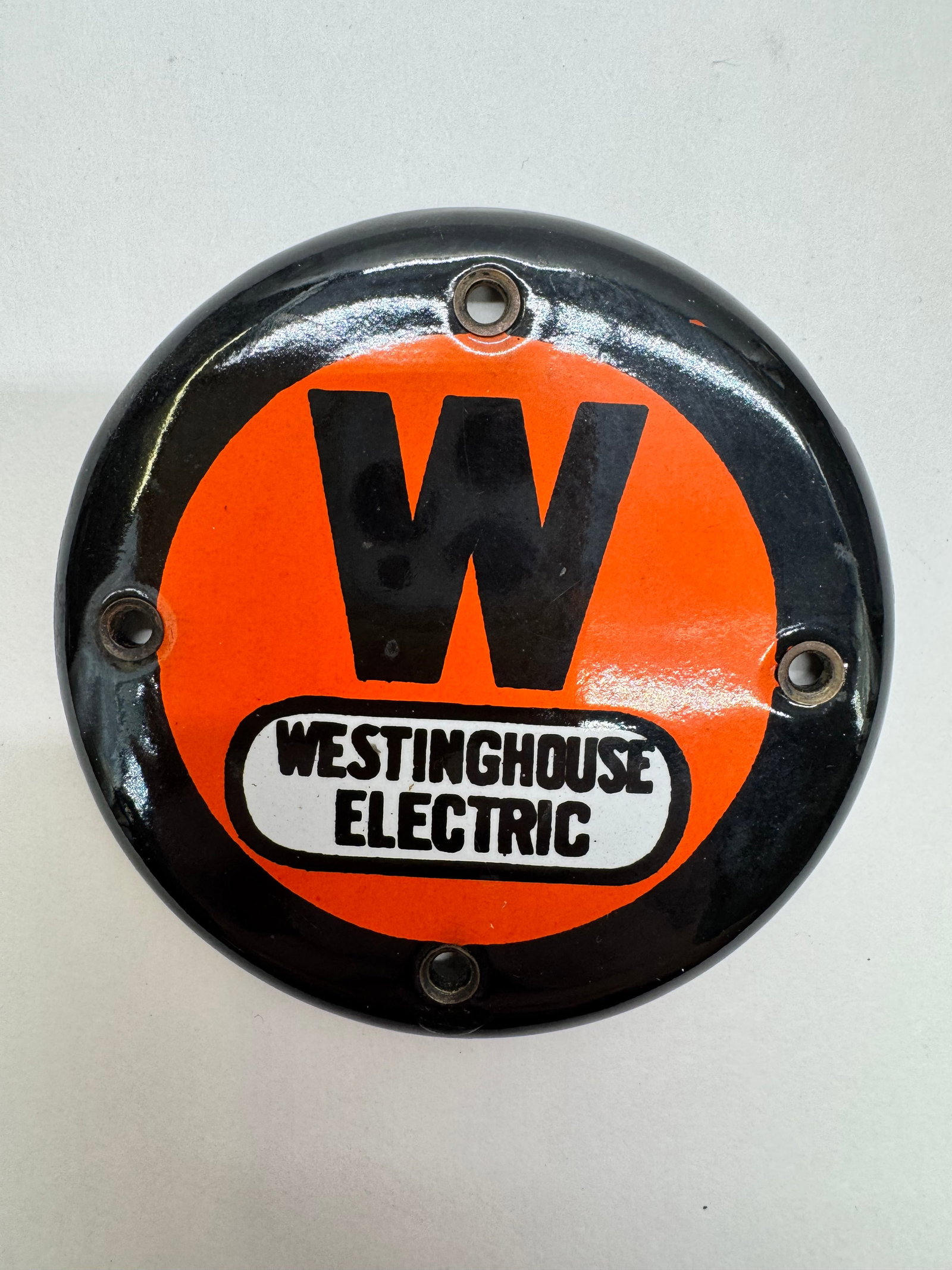 Vintage Westinghouse Electric 3” Porcelain Advertising Emblem: Original Westinghouse Electric porcelain enamel advertising emblem featuring the classic orange and black “W” logo. Measures approximately 3 inches in diameter with four mounting holes. Displa
