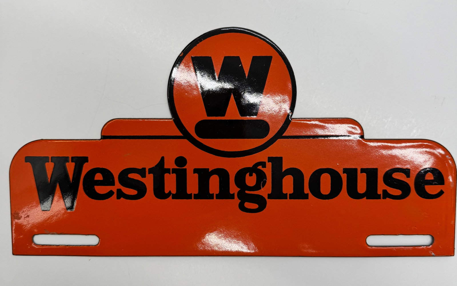 Vintage Westinghouse Electric License Plate Topper Sign: Original embossed steel Westinghouse Electric license plate topper featuring the iconic orange and black design with “W” logo. Displays beautifully with minor age-related wear. Great piece of 