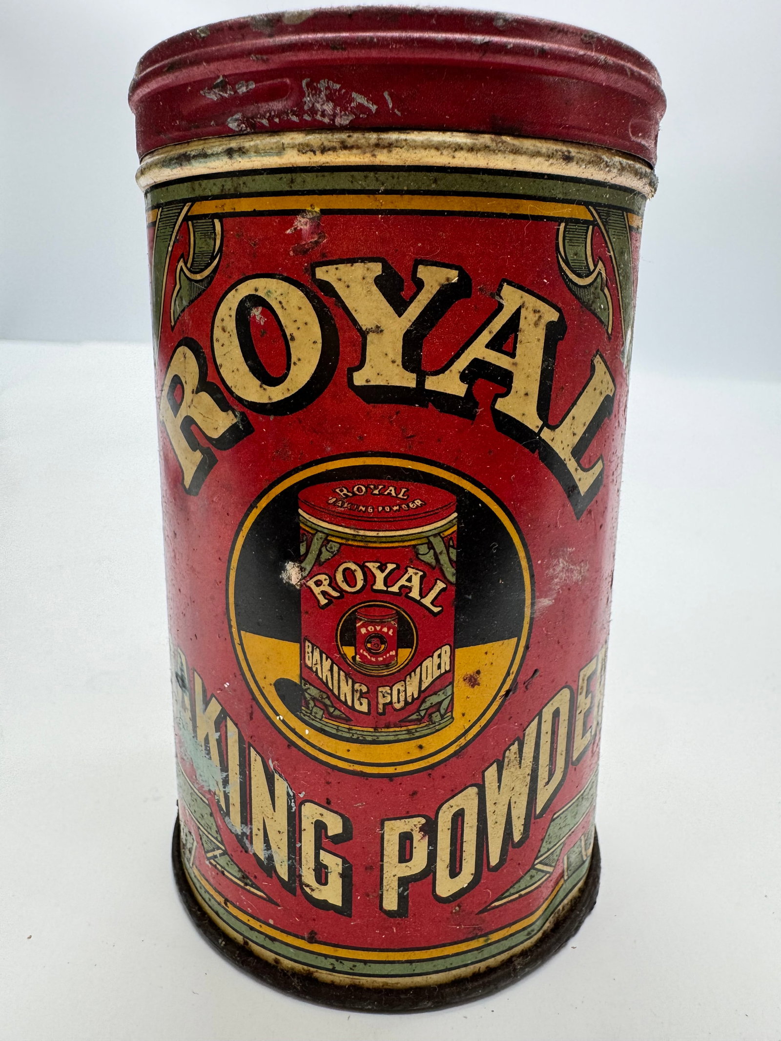 Vintage Royal Baking Powder 12 Oz Tin: Vintage Royal Baking Powder 12-ounce lithographed advertising tin by Standard Brands Inc., New York. Features colorful front graphics, original lid, and recipe panel on the reverse. Displays age-relat