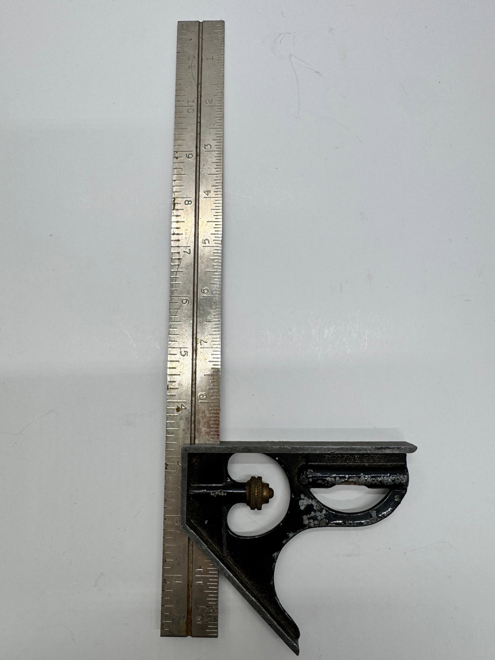 Vintage L.S. Starrett 12” Combination Square Athol Mass USA: Vintage L.S. Starrett combination square featuring a cast iron head with brass adjustment nut and 12-inch steel rule. Made in Athol, Massachusetts, USA. Shows honest age-related wear and paint loss bu
