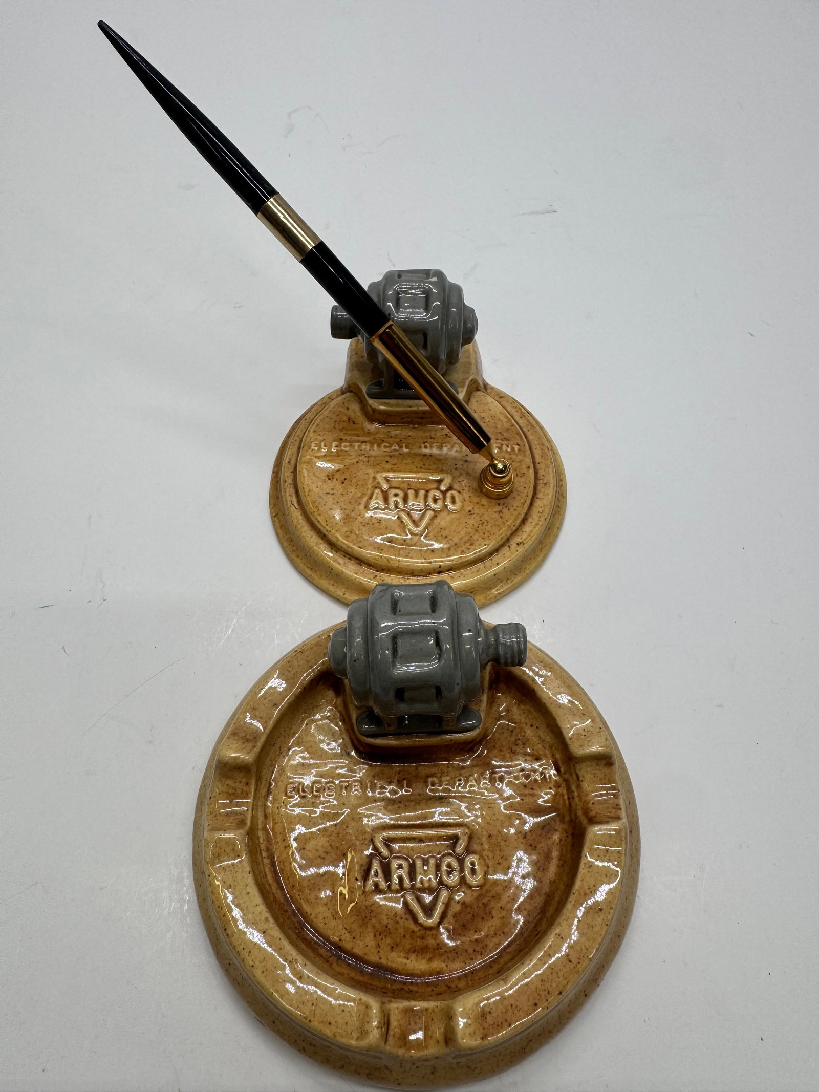Vintage ARCO Electrical Department Ceramic Ashtray & Pen Holder Set: Vintage ARCO Electrical Department ceramic desk accessories featuring miniature electrical motor forms. Includes a matching ashtray and pen holder with original pen. Glazed ceramic construction dating