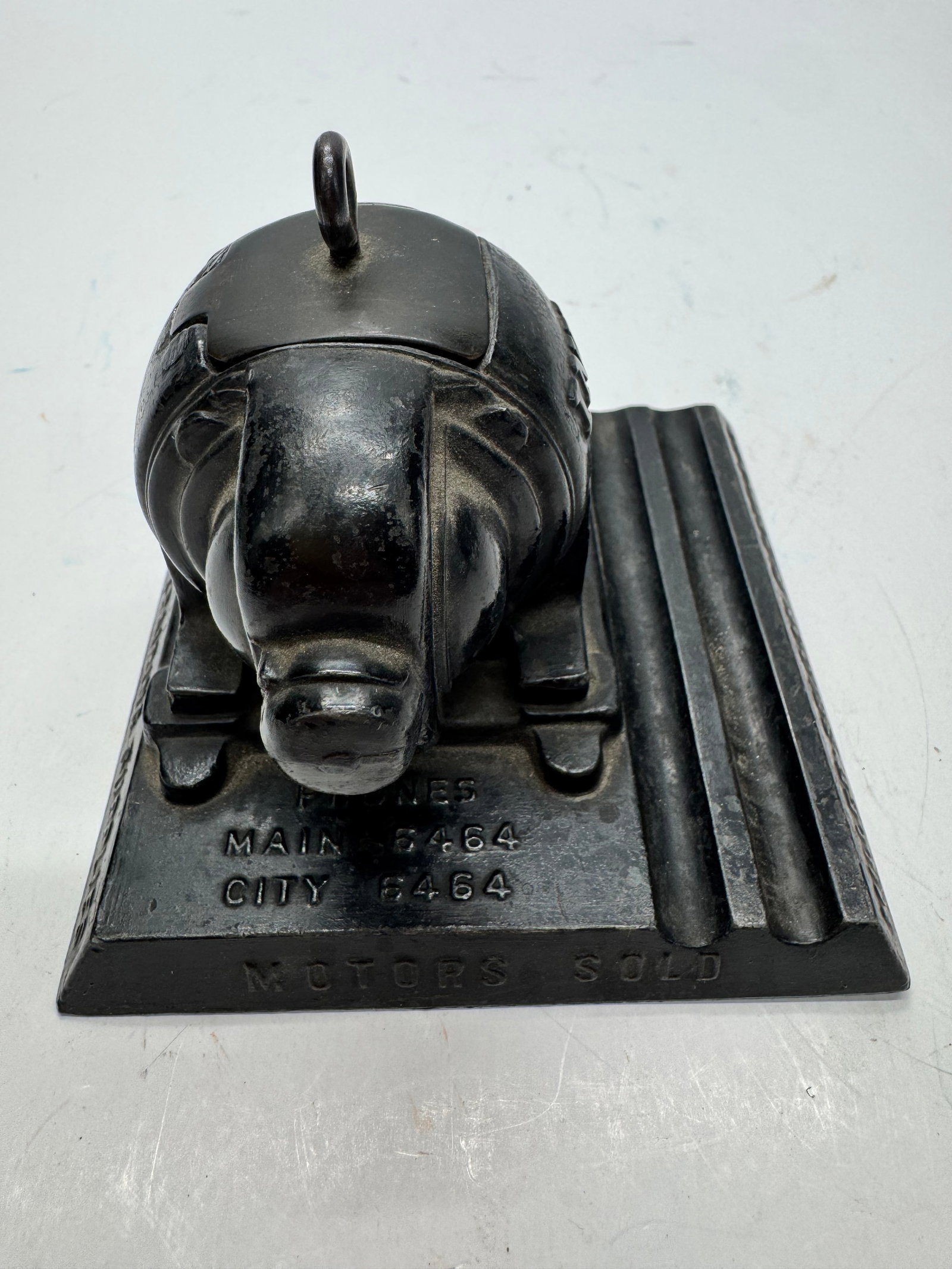 Vintage Electric Motor Salesman Sample Advertising Paperweight: Vintage cast metal electric motor advertising paperweight featuring a miniature motor mounted on a base marked “Motors Sold” with period telephone numbers. Industrial advertising piece with or