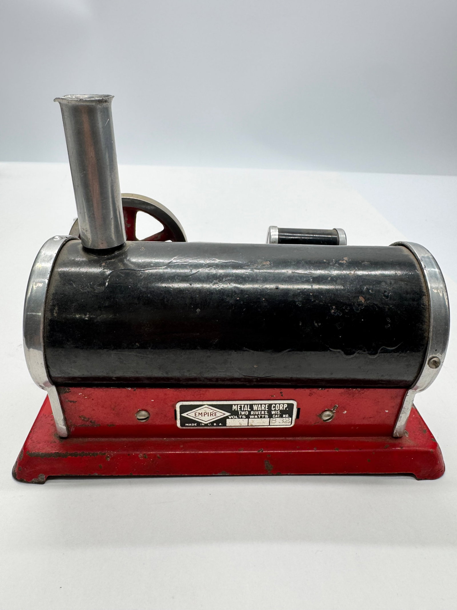 Vintage Empire No. 832 Toy Steam Engine Two Rivers Wisconsin: Vintage Empire Metal Ware Corp. No. 832 toy steam engine. Features a horizontal boiler, flywheel, and original red-painted base. Made in Two Rivers, Wisconsin, U.S.A. Classic mid-century educational s