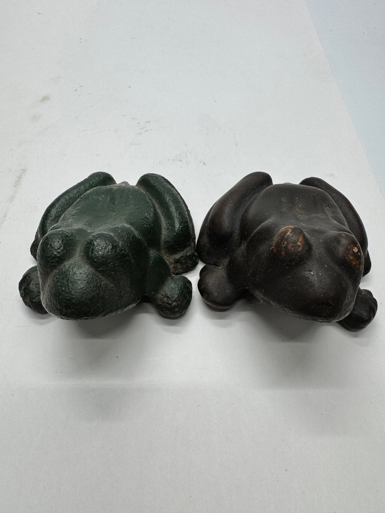 Pair of Vintage Cast Iron Frog Paperweights: Vintage cast iron frog paperweights featuring a stylized frog design with original painted finish. Heavy solid cast iron construction with age-related wear and patina. Great for desk, garden, or folk 