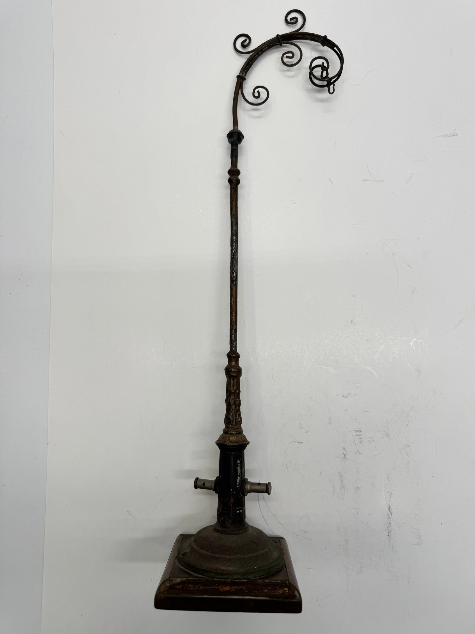 Antique Victorian Cast Iron Scroll Display Stand: Antique Victorian cast iron display stand featuring ornate scrollwork, decorative turned column, and heavy cast base mounted on a wooden platform. The stand retains its original aged patina and includ