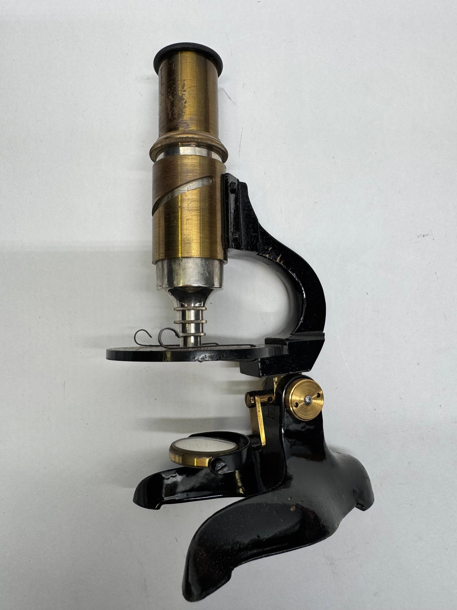 Antique German OPTICA Student Microscope in Wooden Case: Antique German OPTICA student compound microscope housed in its original fitted wooden case. Features a brass body tube, black enameled cast iron horseshoe base, adjustable mirror, and original German