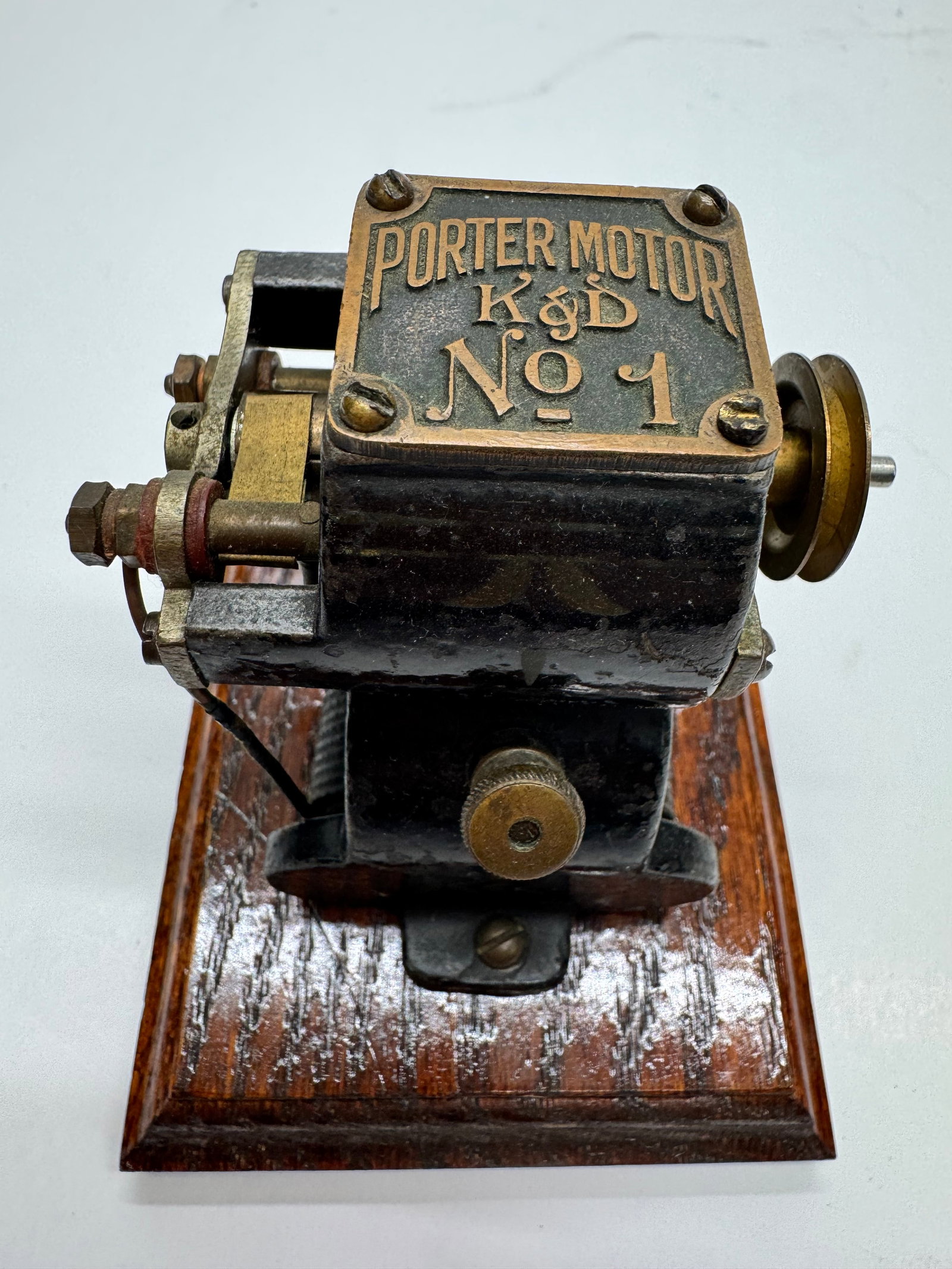 Antique K&D Porter Motor No. 1 Electric Toy Motor: Porter Motor No. 1 electric toy motor, dating to the early 1900s. Features a cast iron frame with an original brass nameplate mounted on a wooden base. Commonly used for early electrical experiments, 