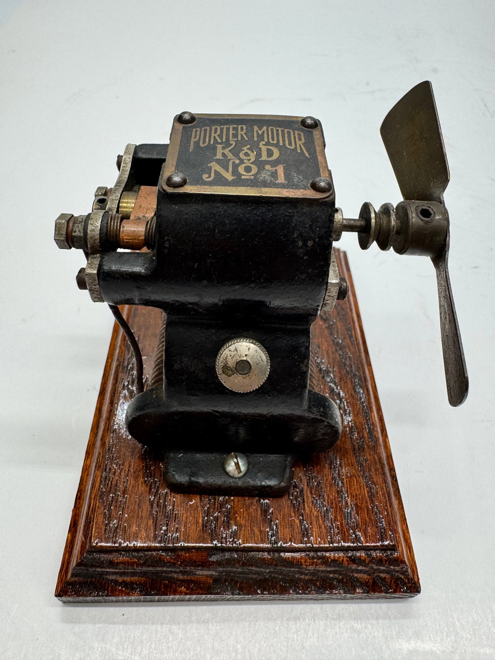 Antique K&D Porter Motor No. 1 Battery Operated Toy Motor: Antique Porter Motor No. 1 manufactured by Kendrick & Davis (K&D) in the early 20th century. Features a cast iron body with original black finish, gold pinstriping, brass nameplate, and wooden base. D
