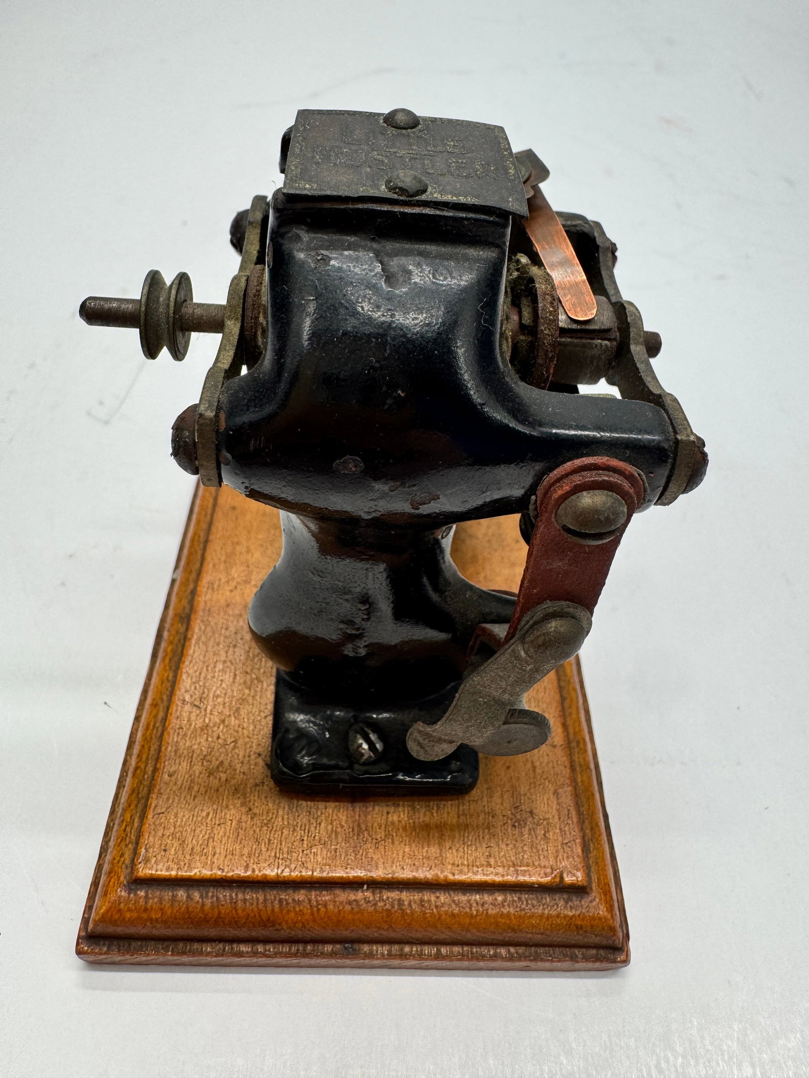 Antique Knapp “Little Hustler” Electric Toy Motor: Antique Knapp “Little Hustler” electric toy motor, manufactured in the early 1900s by the Knapp Electric Corporation. Features a cast iron frame mounted on a wooden base with exposed field coi
