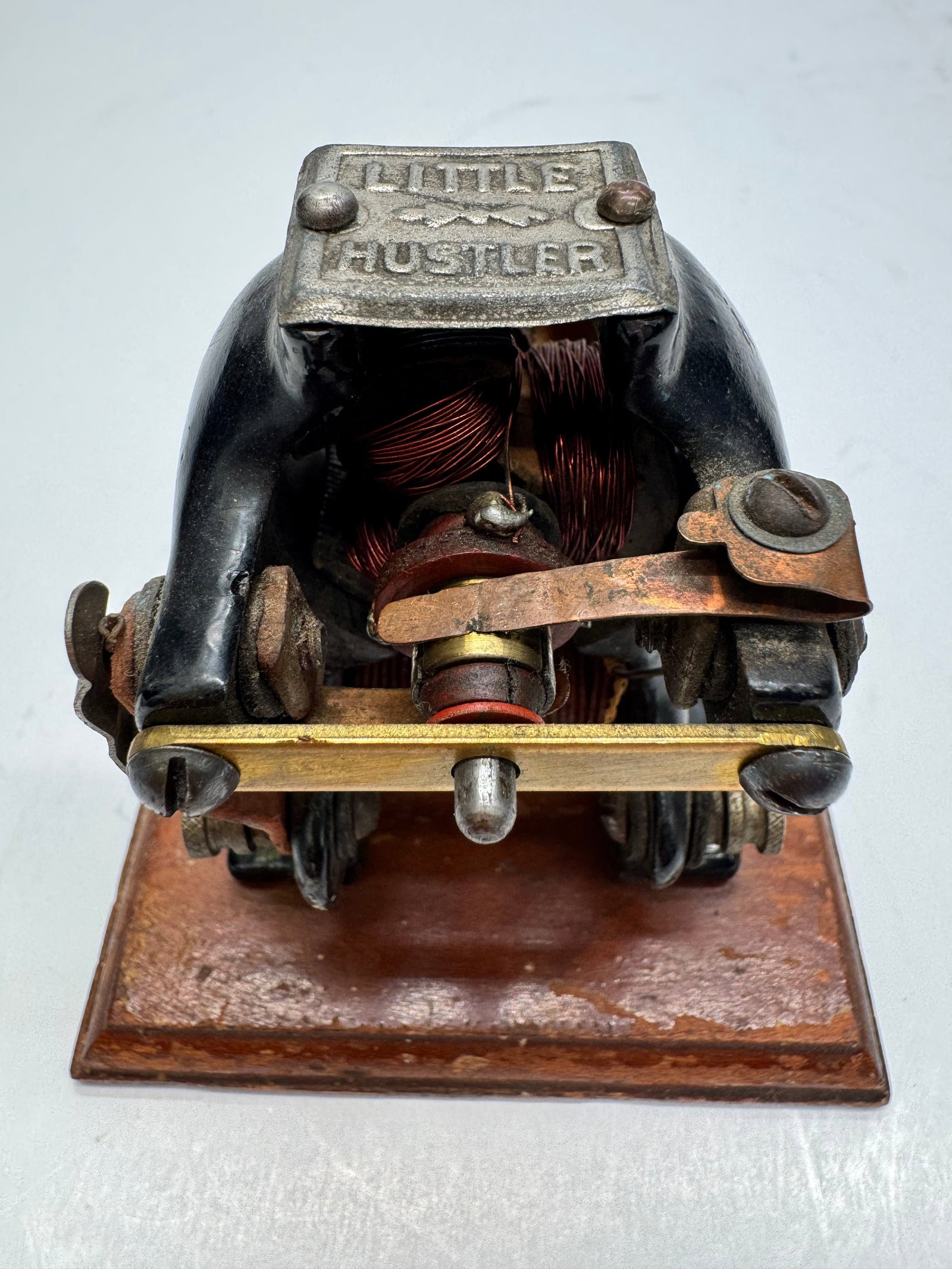 Antique Knapp Electric “Little Hustler” DC Toy Motor: Antique Knapp Electric Corporation “Little Hustler” toy electric motor, dating to the early 1900s. Features a cast iron frame mounted on a wooden base with an original brass nameplate and expo