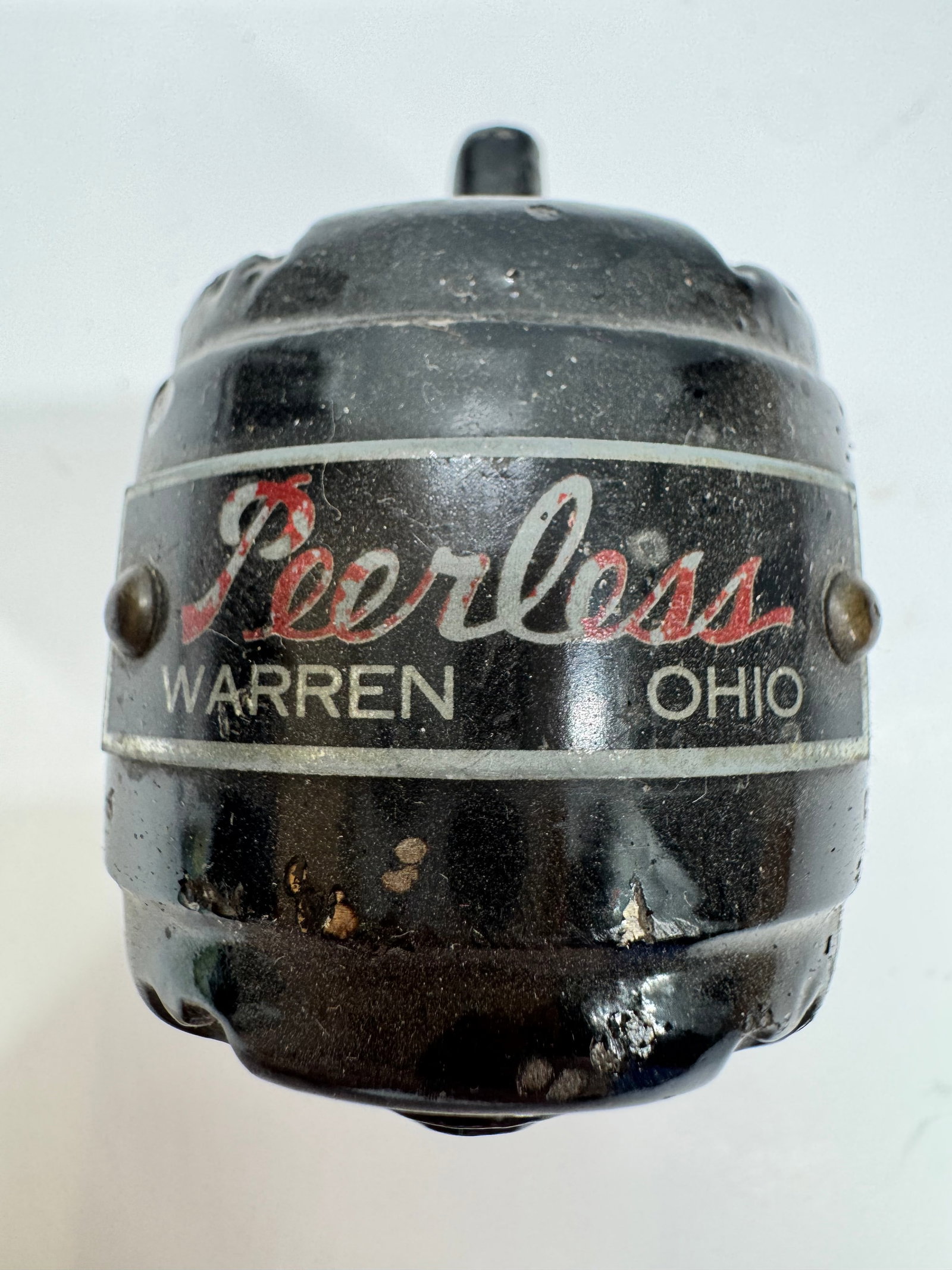 Vintage Peerless Warren Ohio Motor Paperweight: Vintage Peerless Warren, Ohio cast metal motor paperweight modeled after a Peerless electric motor. Features the original “Peerless – Warren, Ohio” logo with a black painted finish and cast 