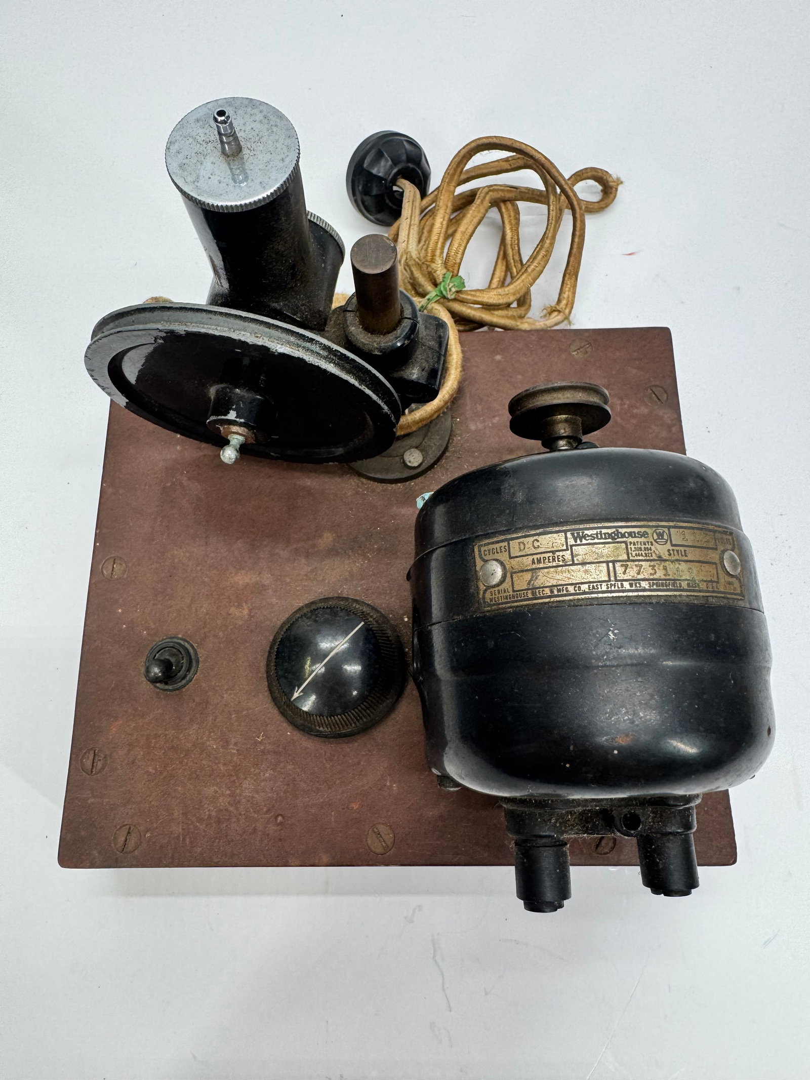 Vintage Westinghouse DC Motor Electrical Demonstrator 115V: Vintage educational electrical demonstration unit featuring a Westinghouse 115-volt DC motor mounted on a wooden base with a belt-driven generator/dynamo, control switch, and rheostat. Manufactured by